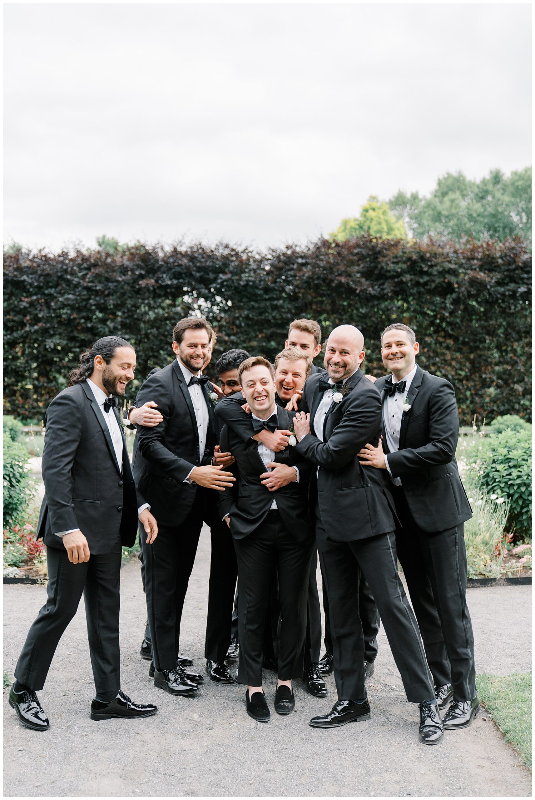 groomsmen hug groom