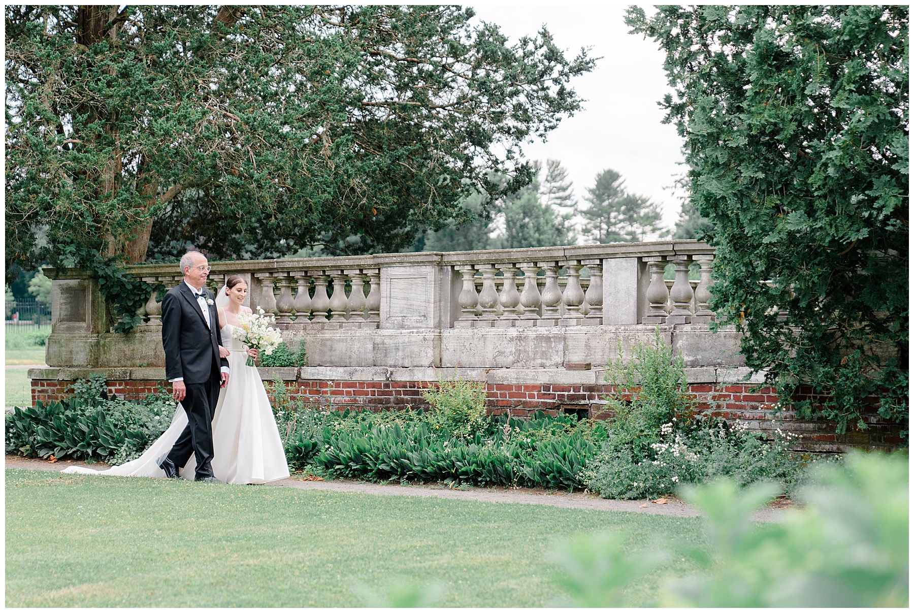 bride walks toward ceremony with father