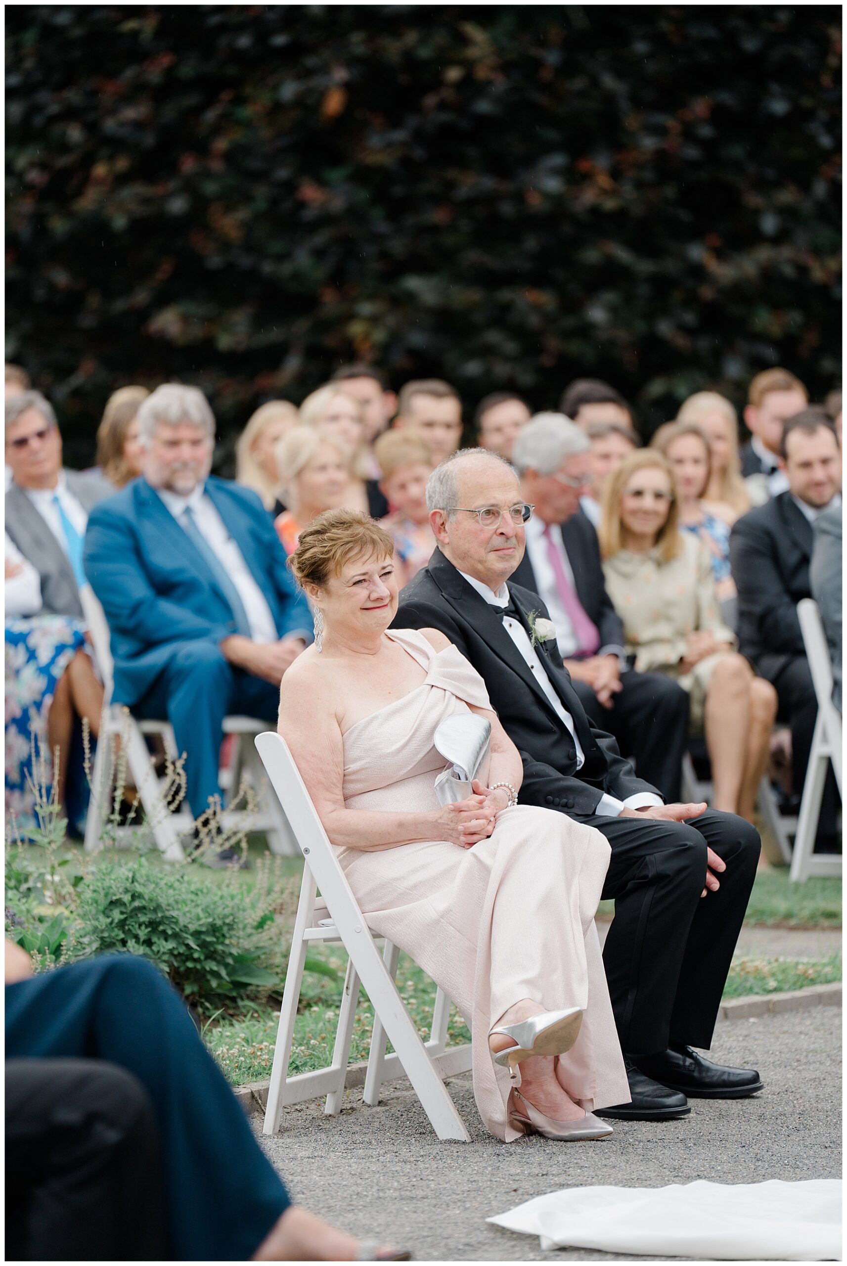 guests watch outdoor wedding ceremony 