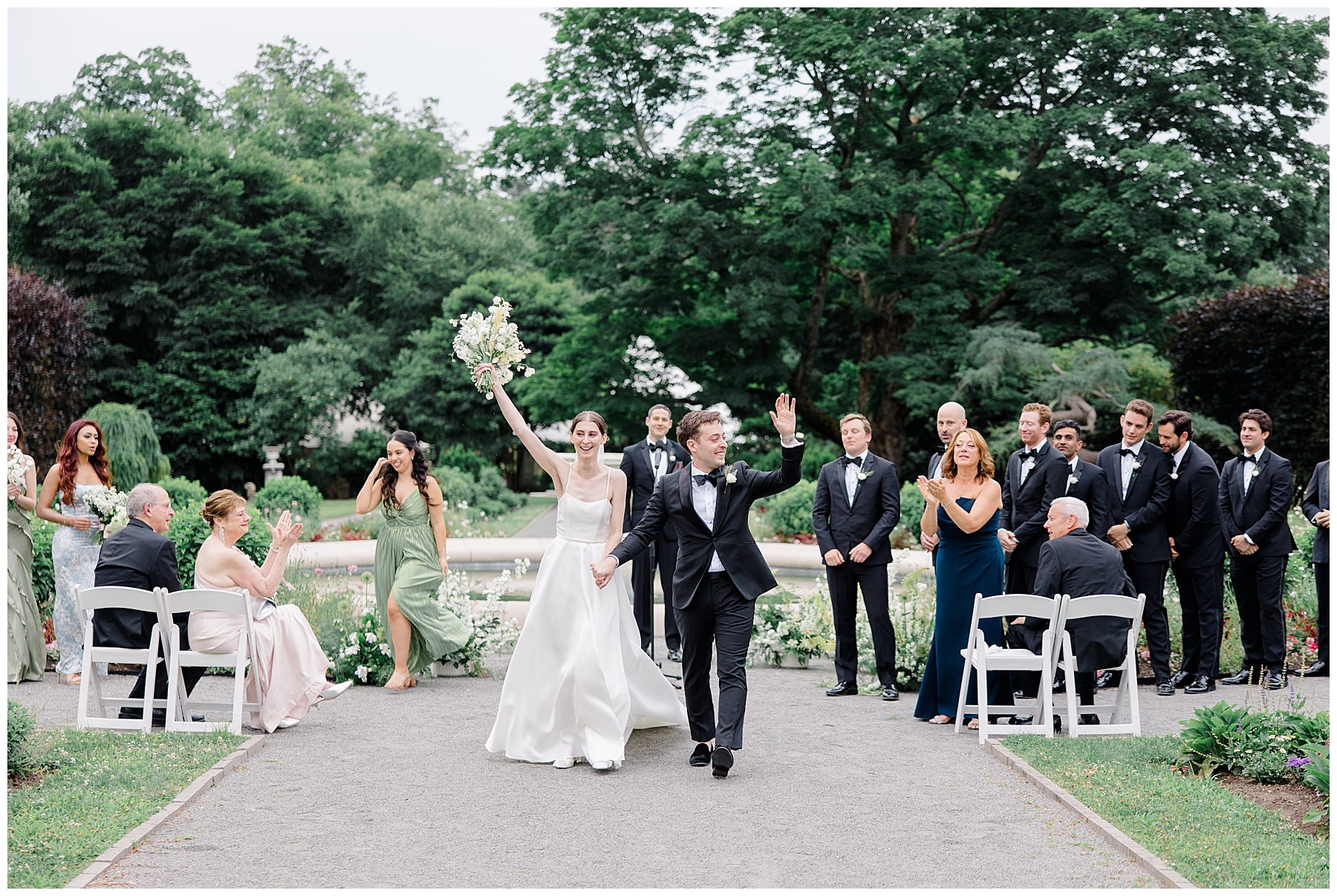 newlyweds celebrate as they exit wedding ceremony