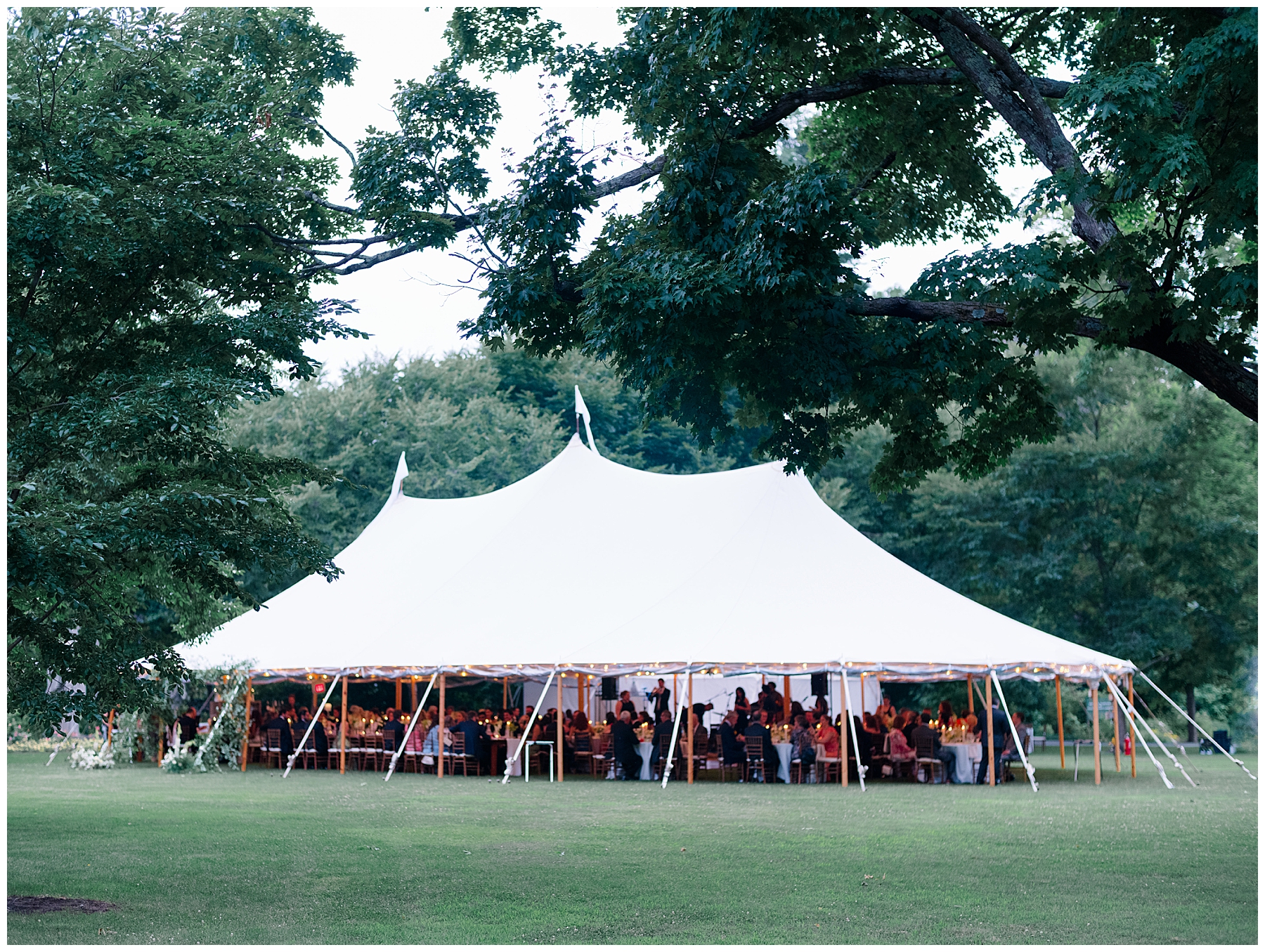 wedding guests celebrate newlyweds at tented reception at The Gardens at Elm Bank  