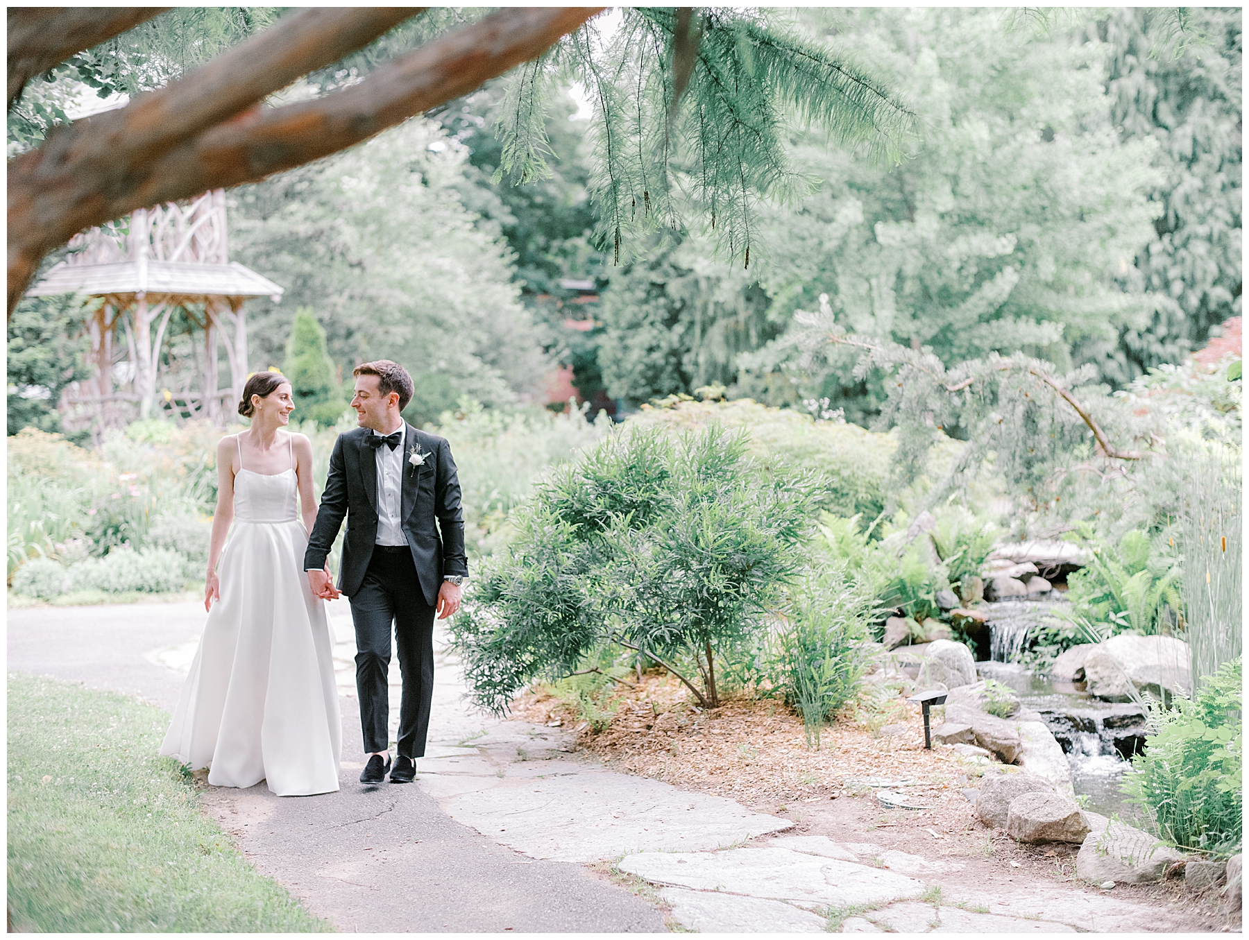 newlyweds walk through the gardens 