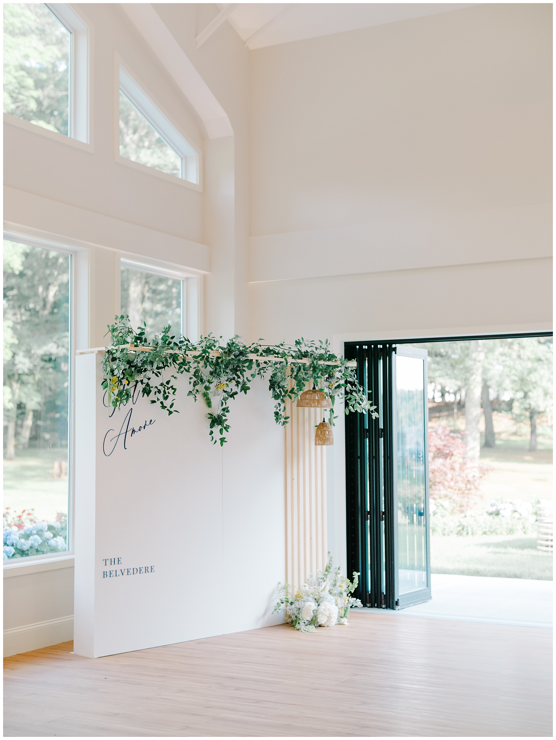 photo wall prop in with greenery and sleek design 