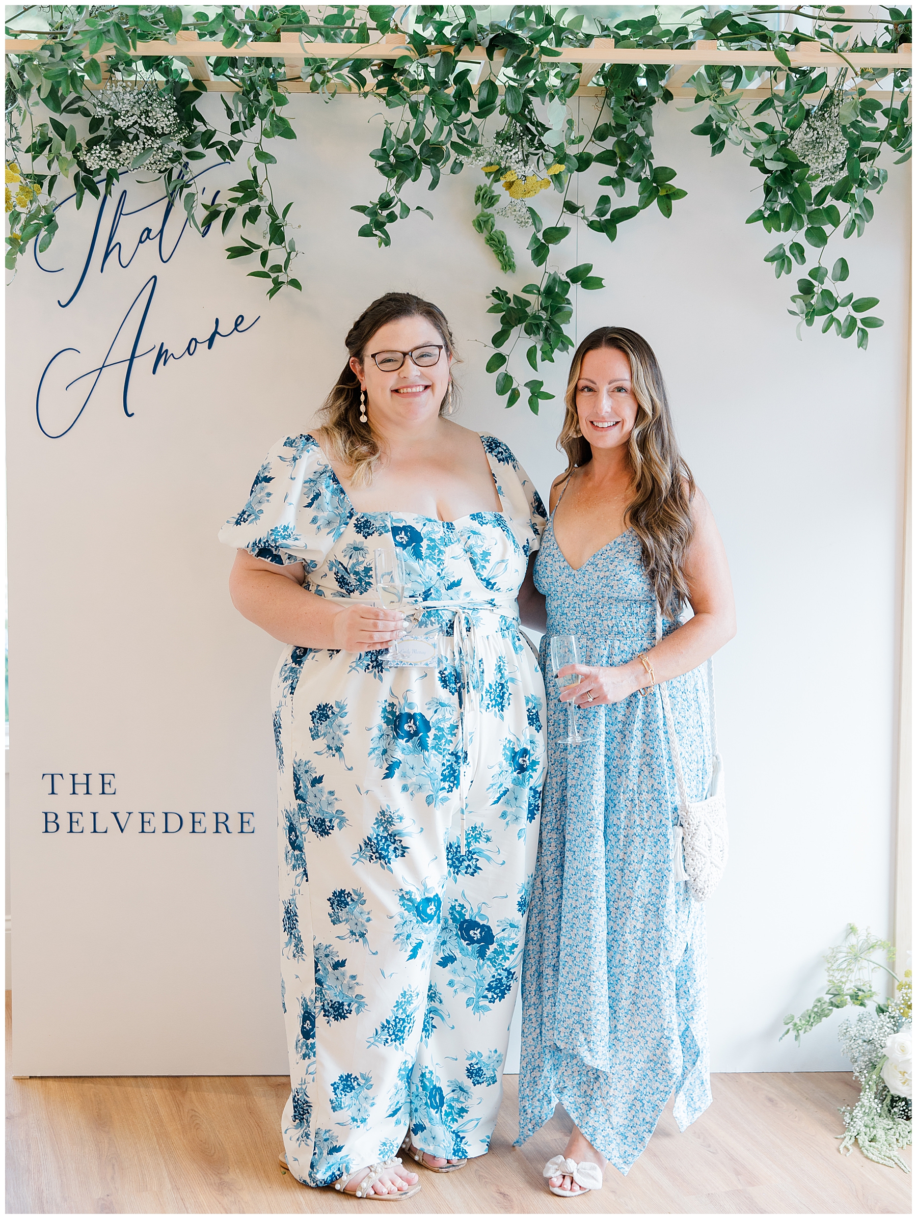 guests pose in front of photo wall