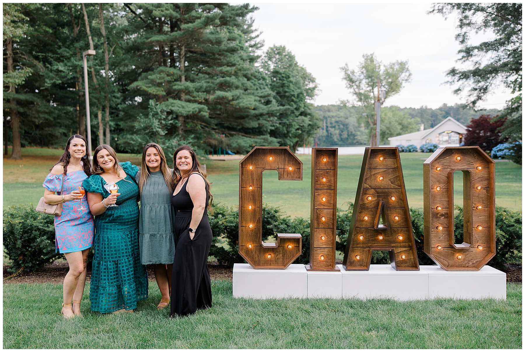 attendees stand by light up CIAO sign