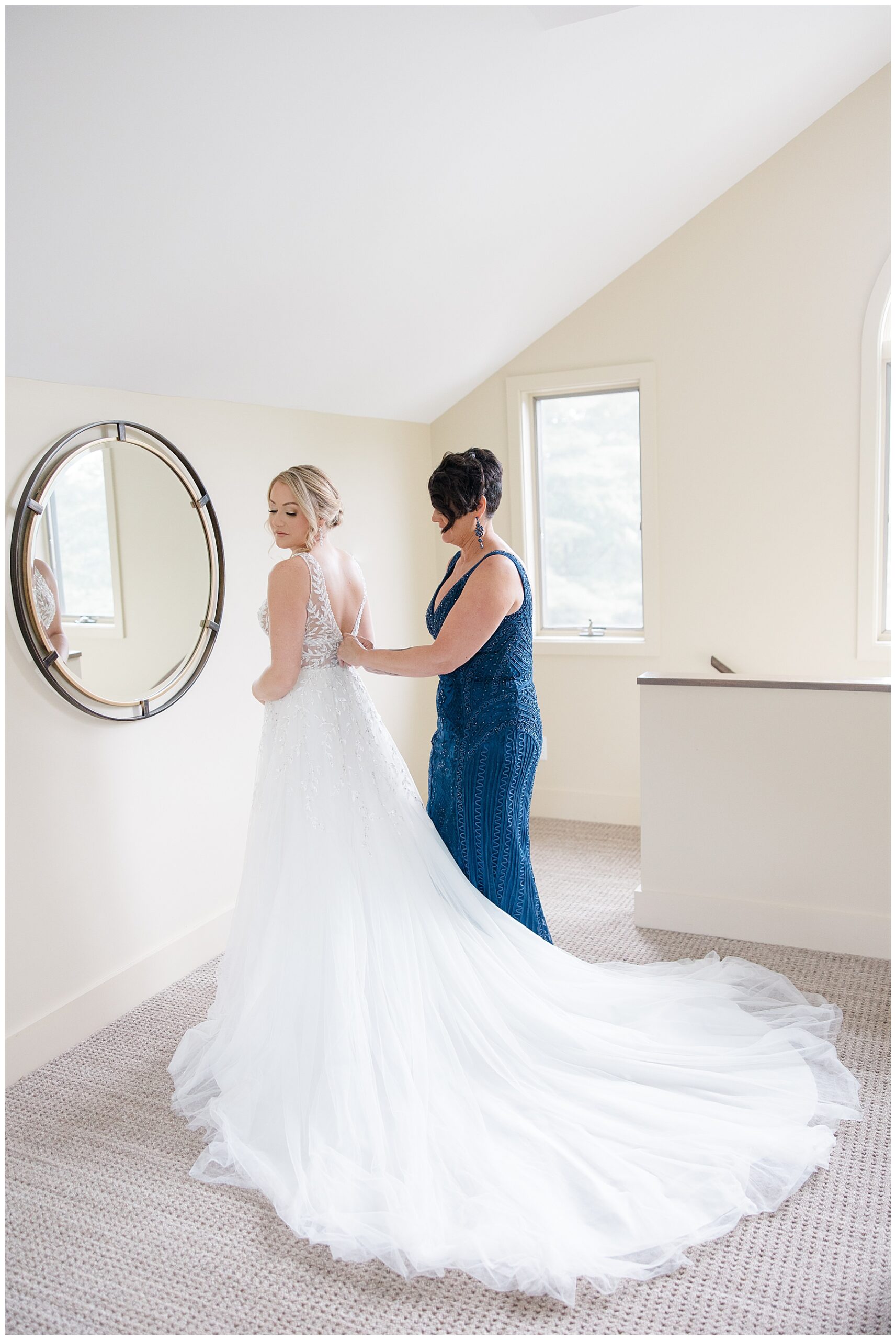 bride getting into wedding dress