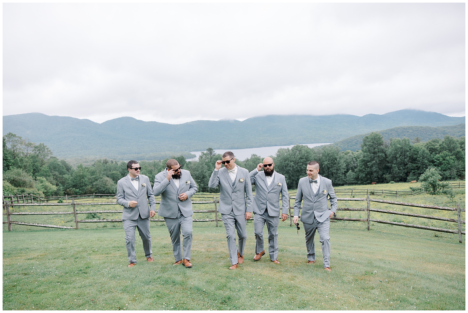 groom and groomsmen walk on mountain top