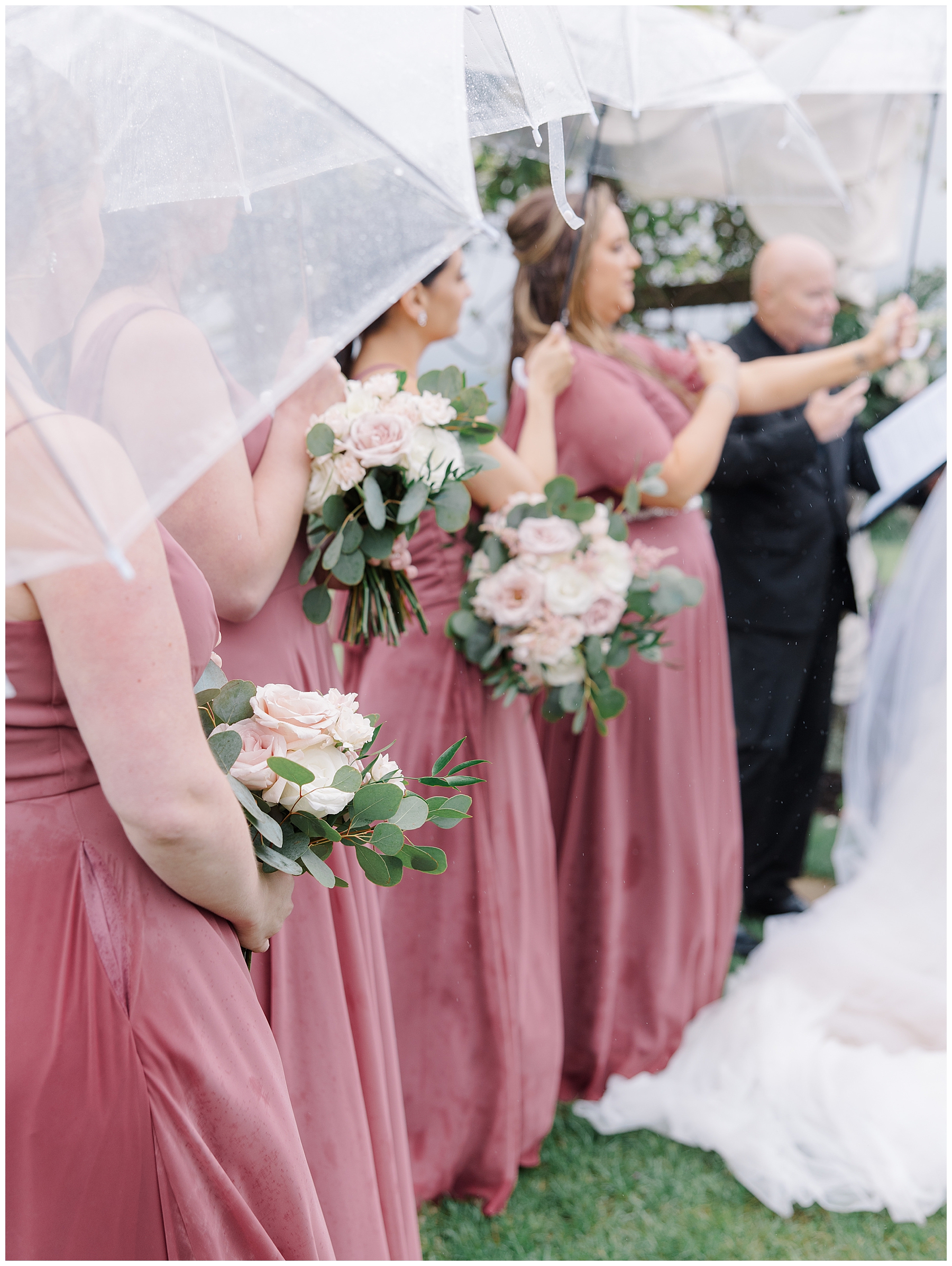 wedding party holds clear umbrella