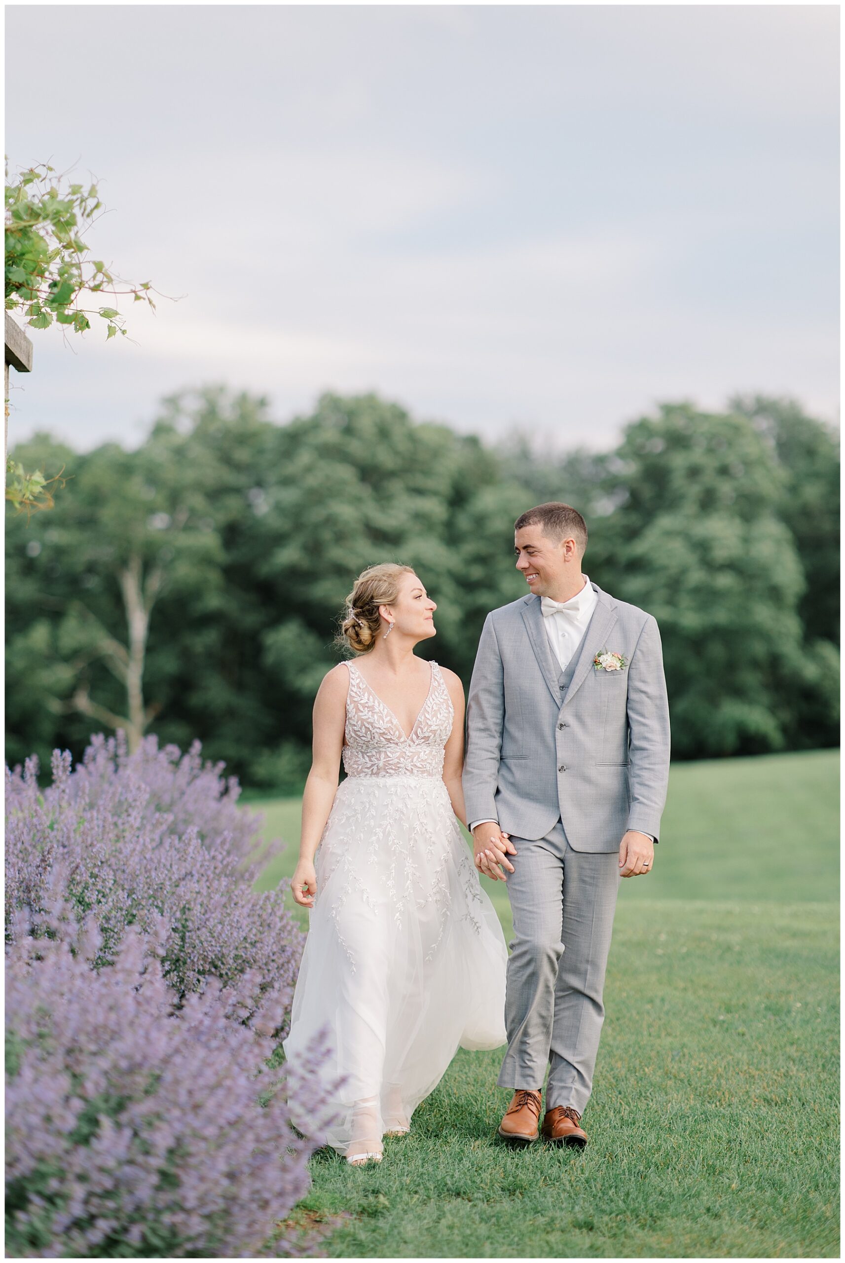 newlyweds walk together holding hands