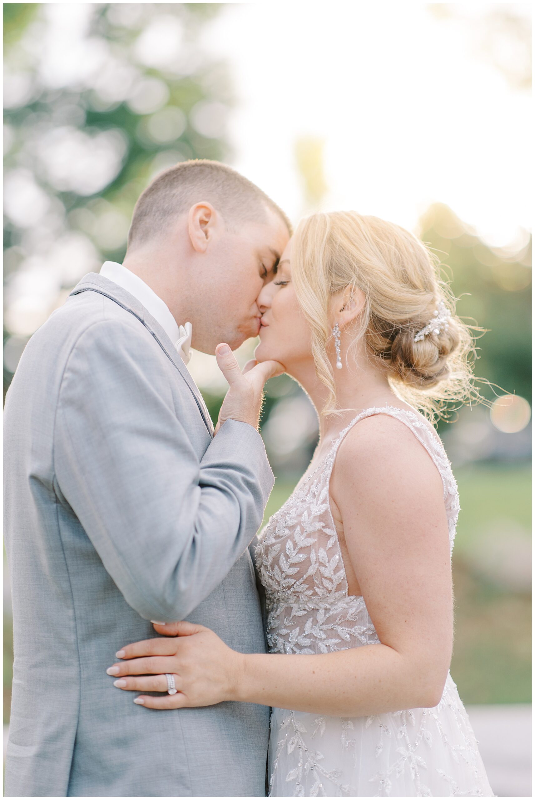 newlyweds kiss during sunset photos