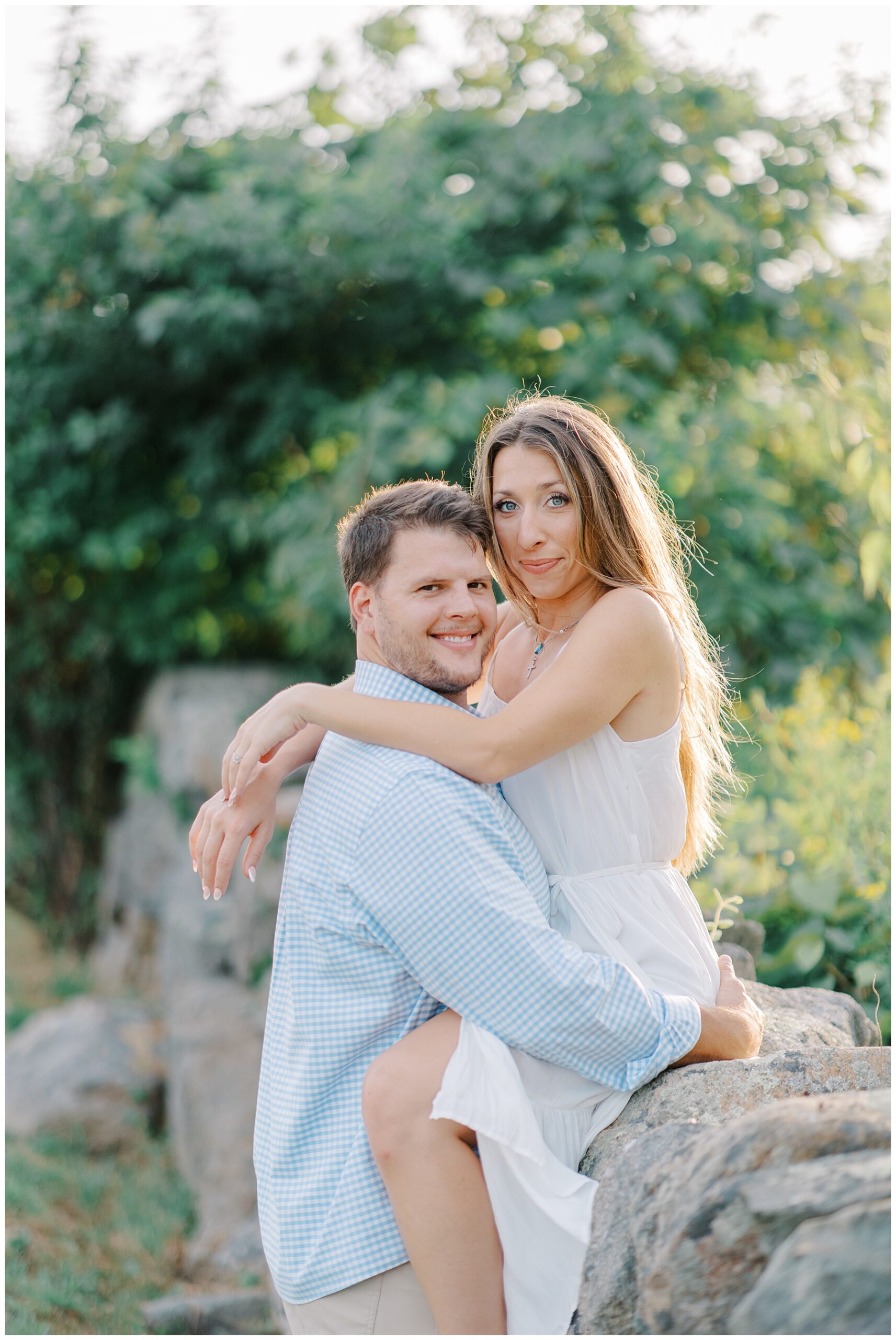 engaged couple in grassy area during Westport engagement