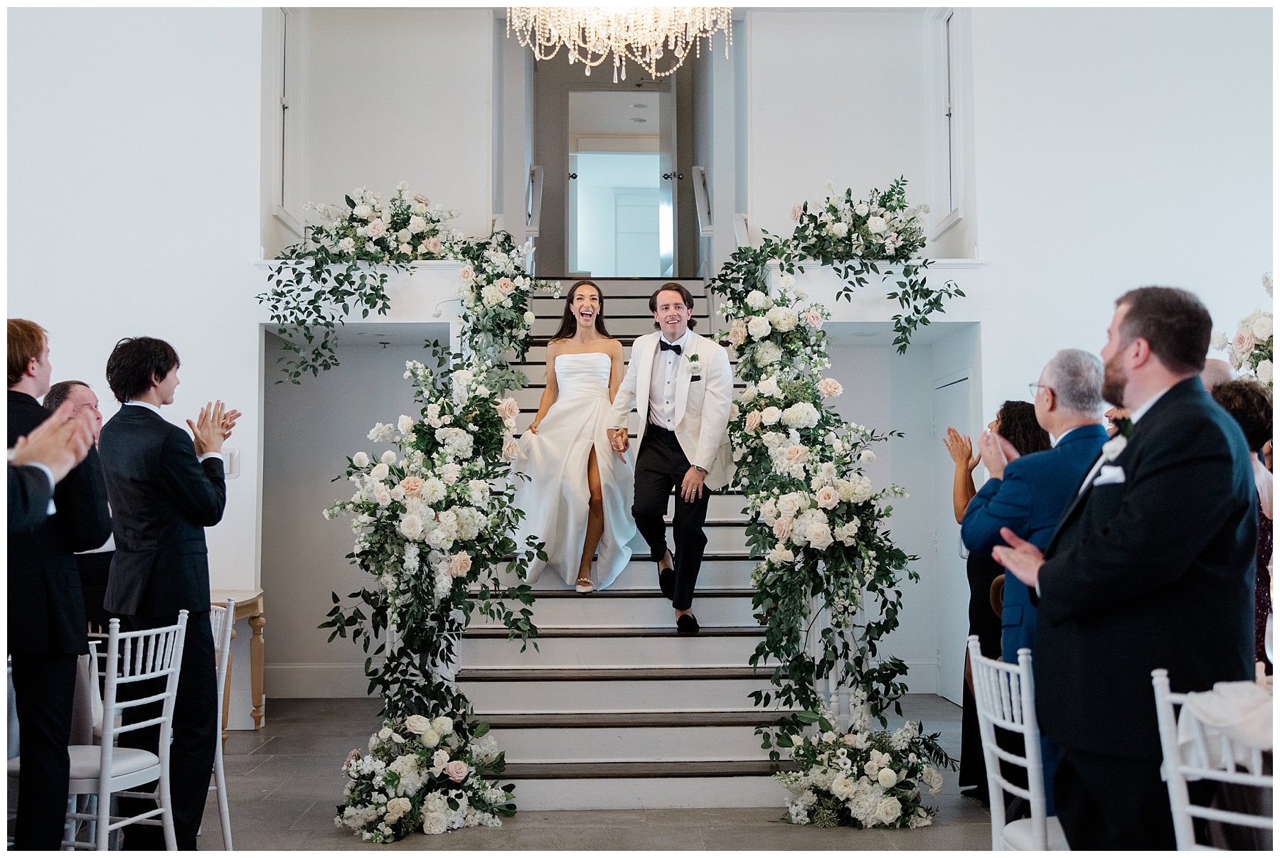 bride and groom descending down stairs at Belle Mer, A Longwood Venue