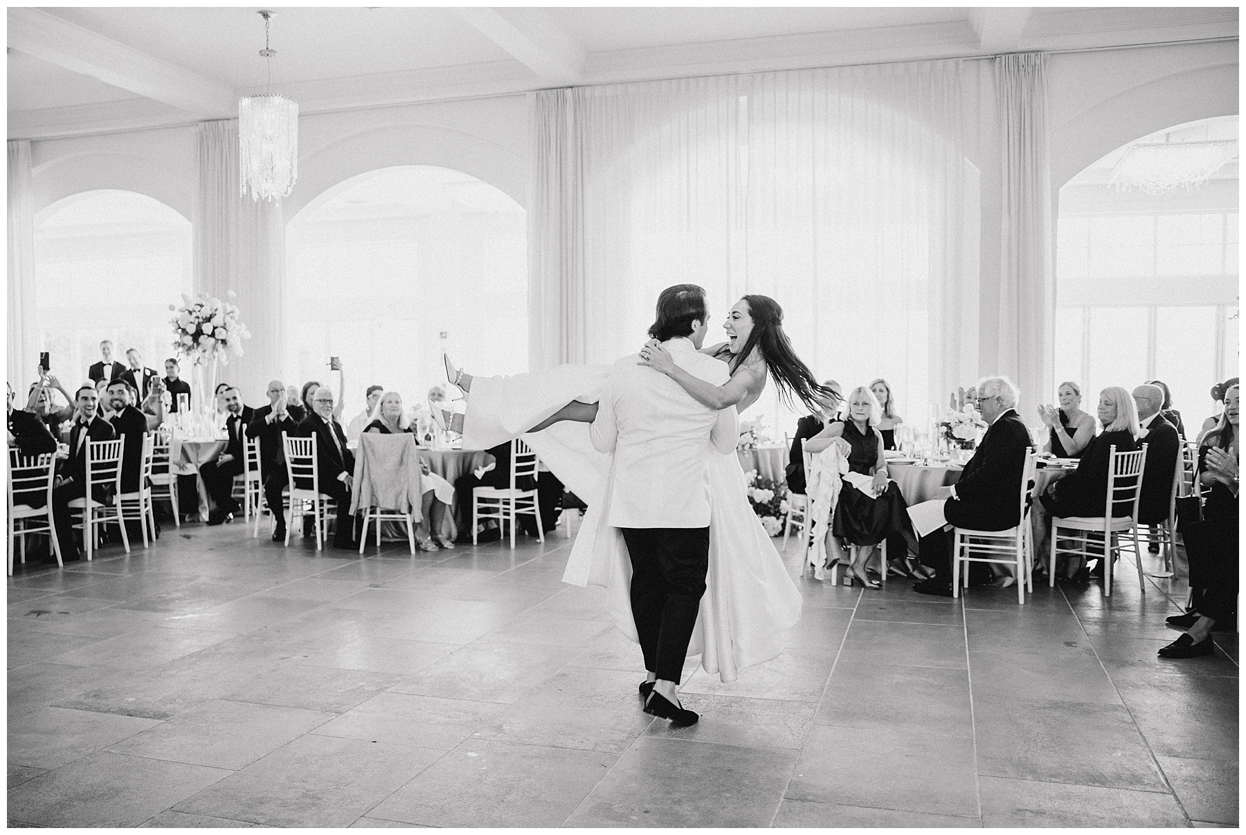 groom picks up bride in his arms