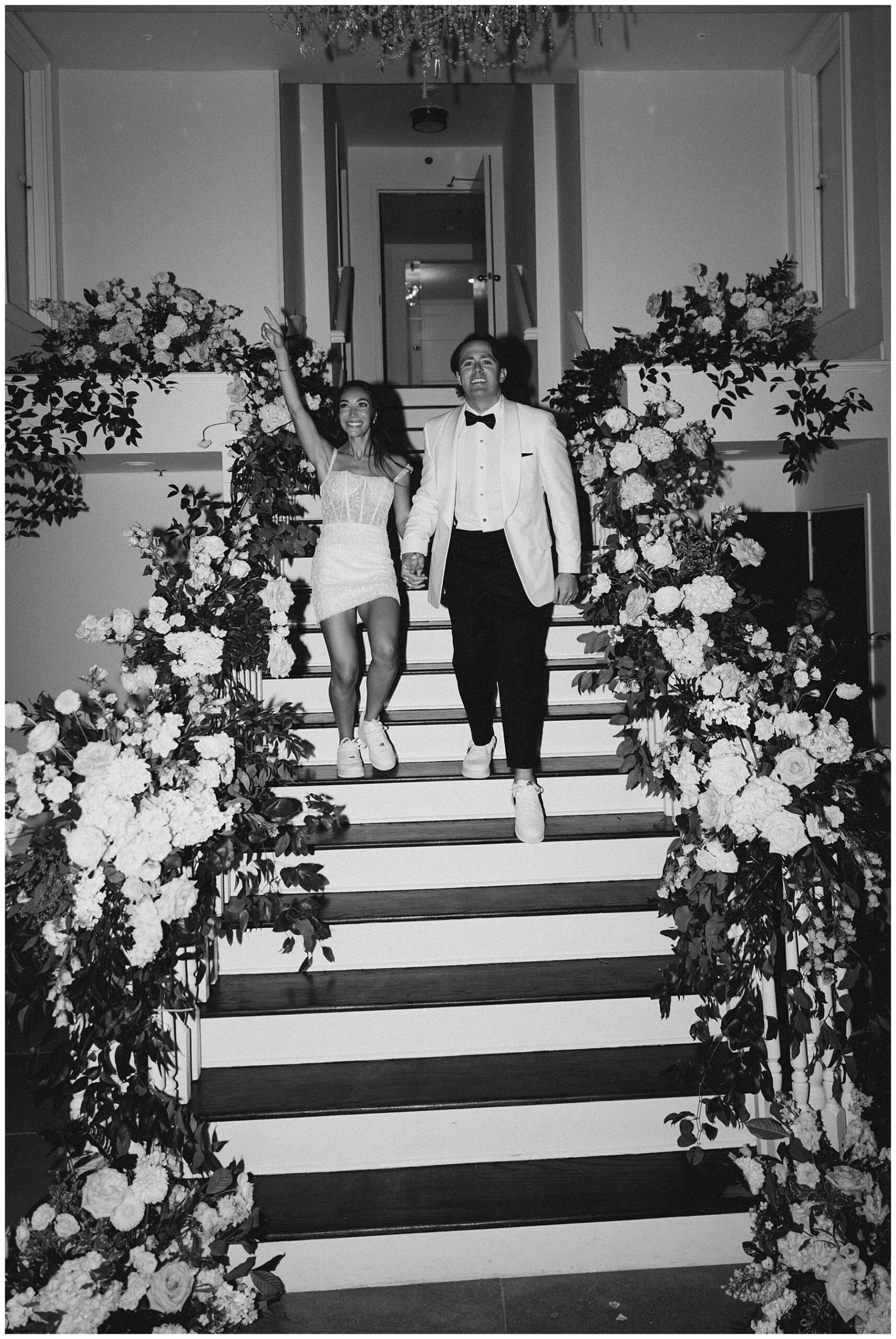newlyweds coming down stairs during wedding exit