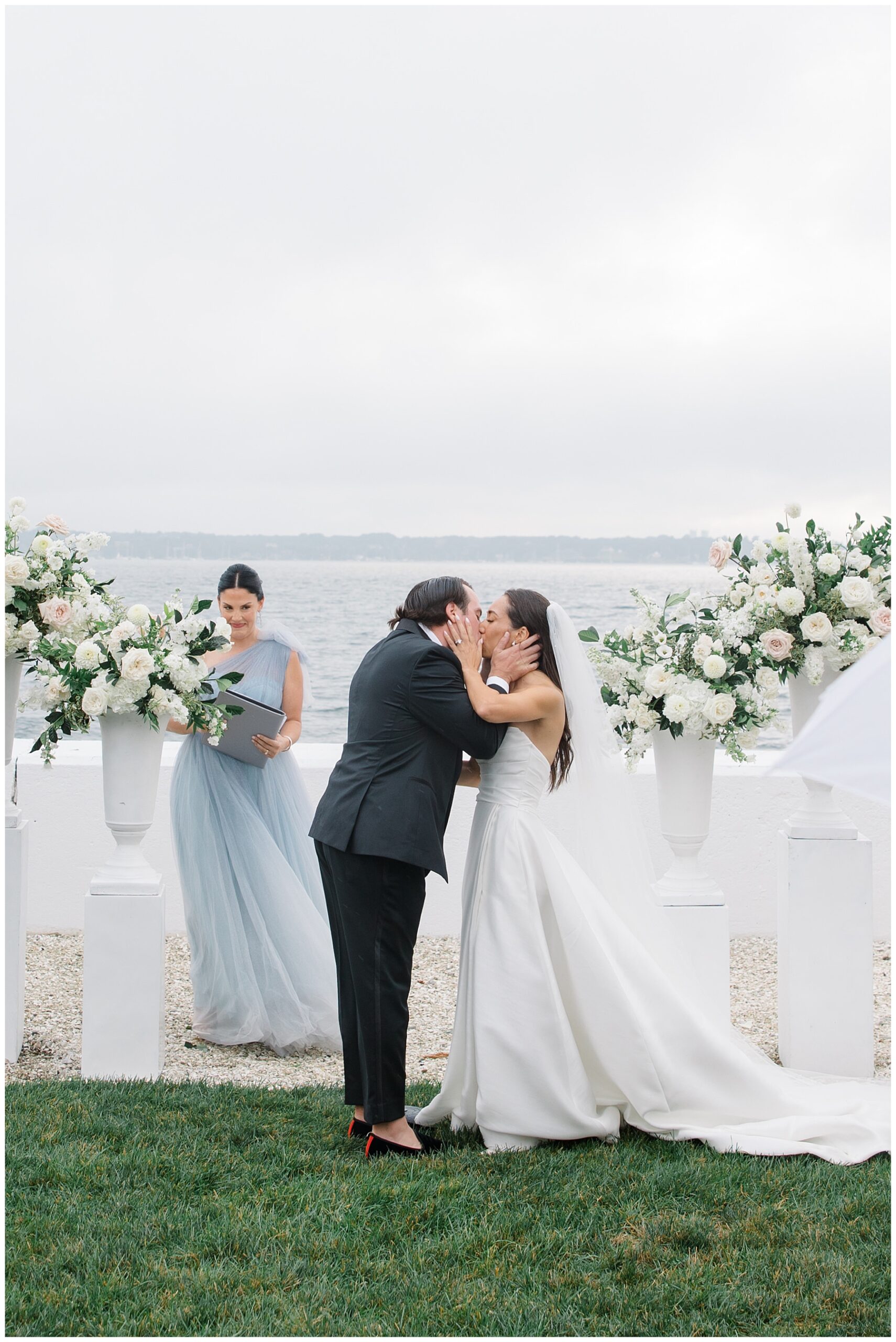 bride and groom kiss at altar