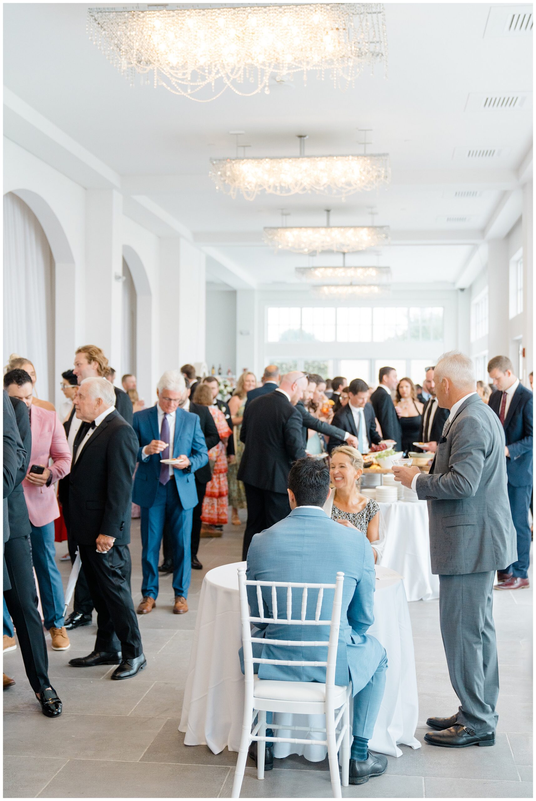 guest mingle during cocktail hour at Coastal Wedding at Belle Mer, A Longwood Venue in Newport