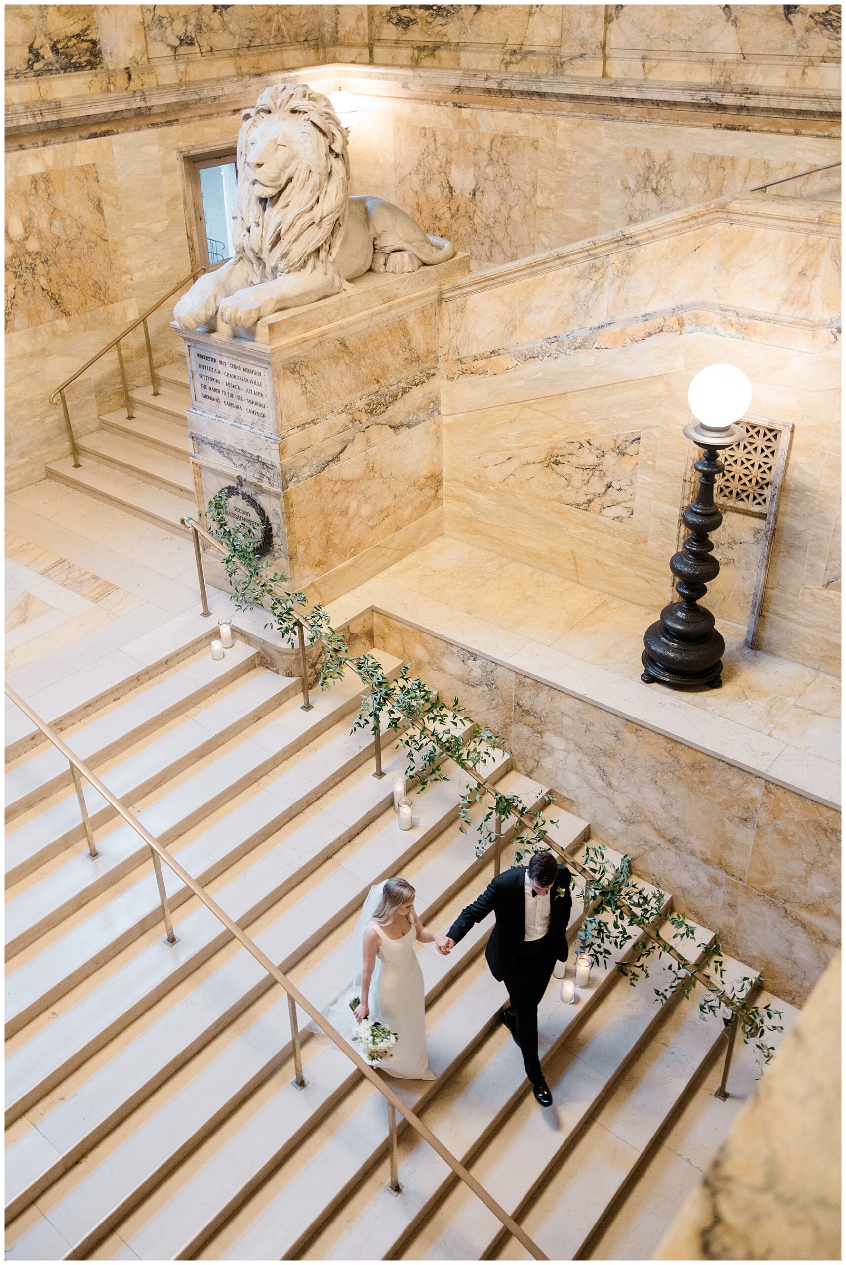 newlyweds walk down grand staircase