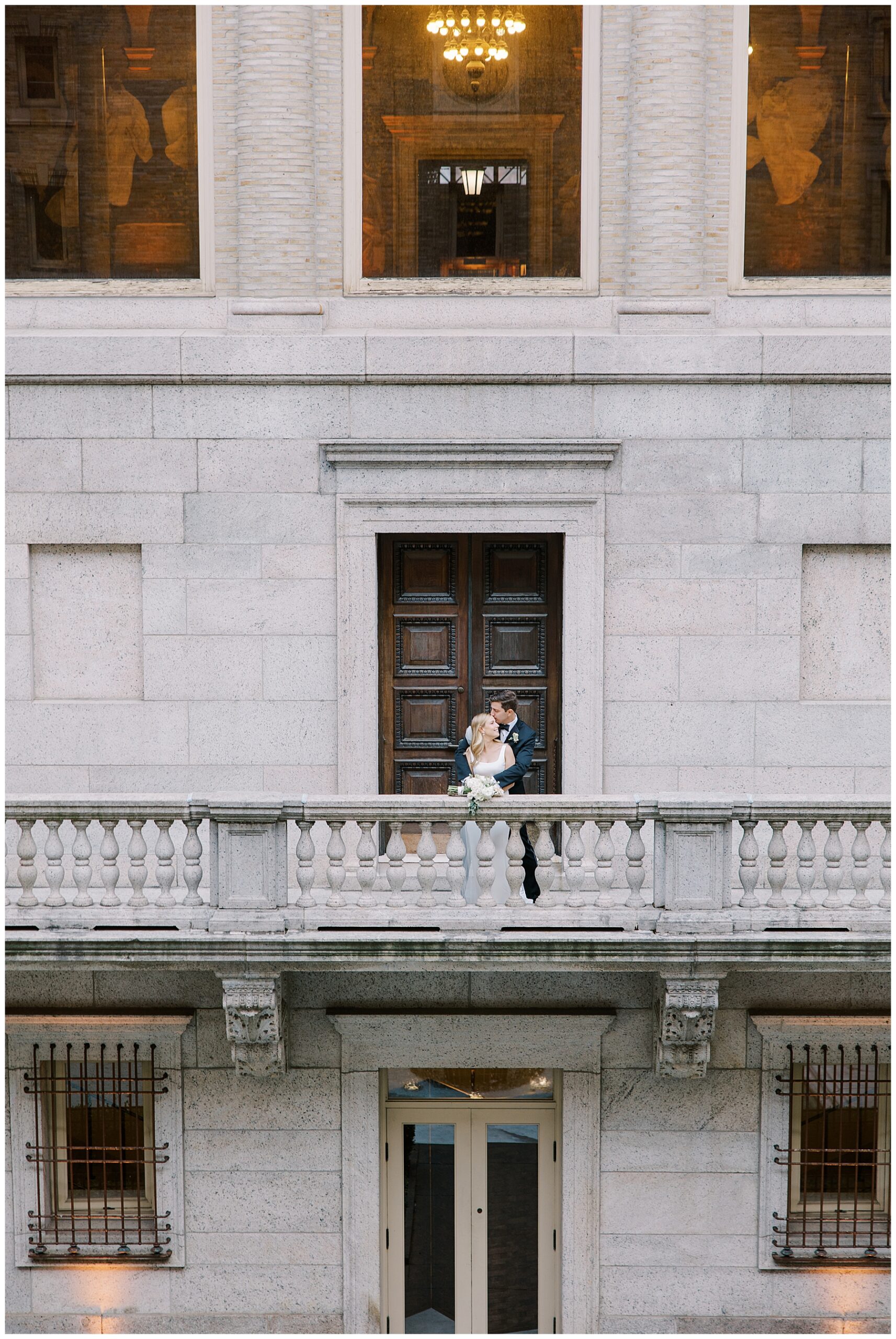 timeless wedding photos of bride and groom on balcony