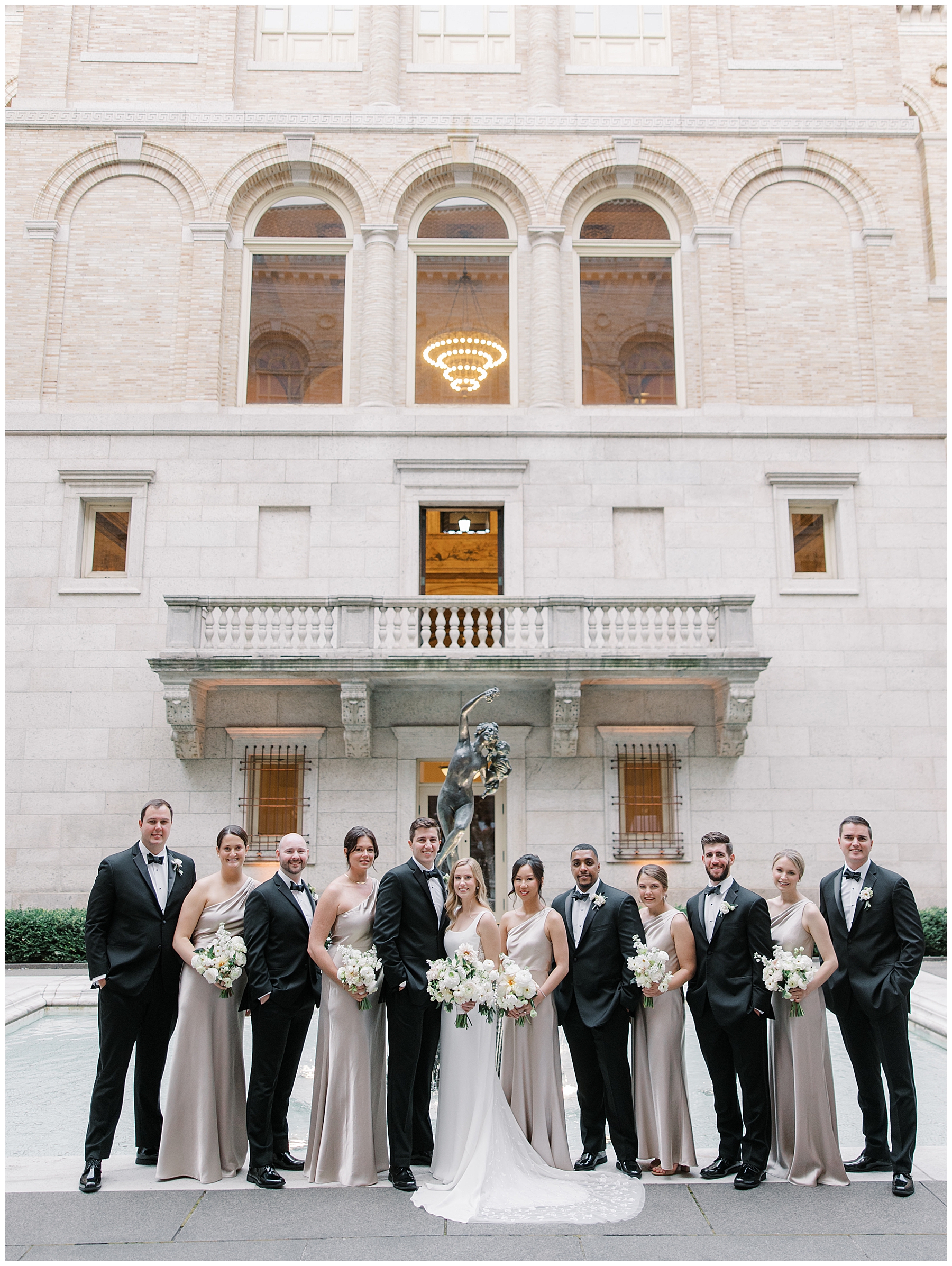 wedding party in champagne dresses and black tuxes