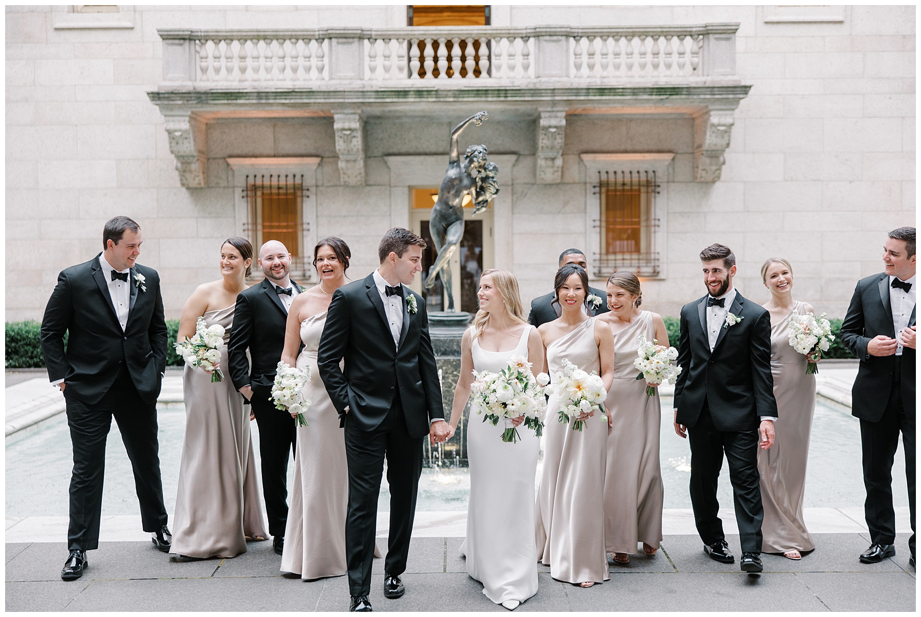 bridal party walks with bride and groom
