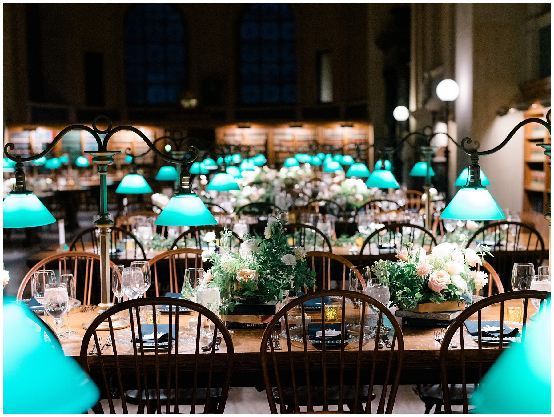 wedding reception tablescape featuring flowers and iconic reading lights of library