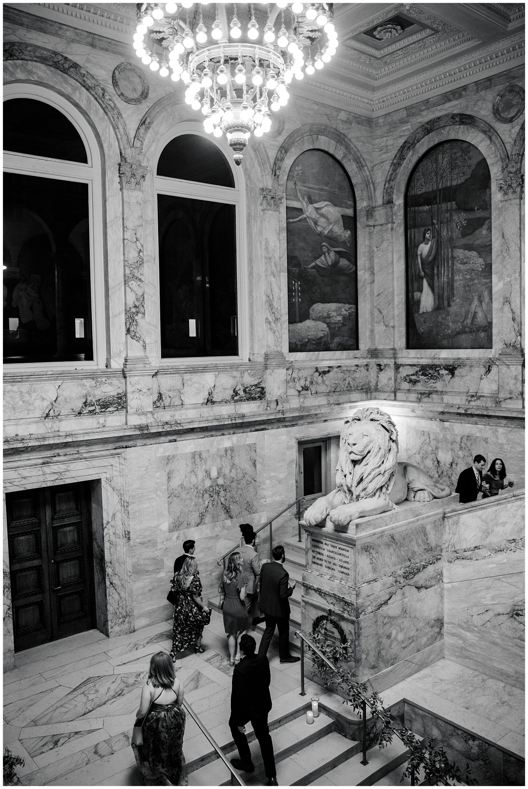 guests walk up grand staircase of library