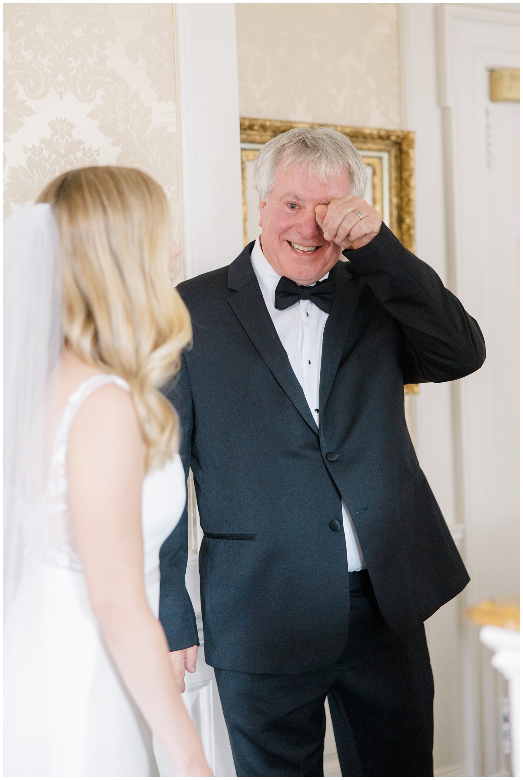 emotional father wipes away tears during first look with daughter
