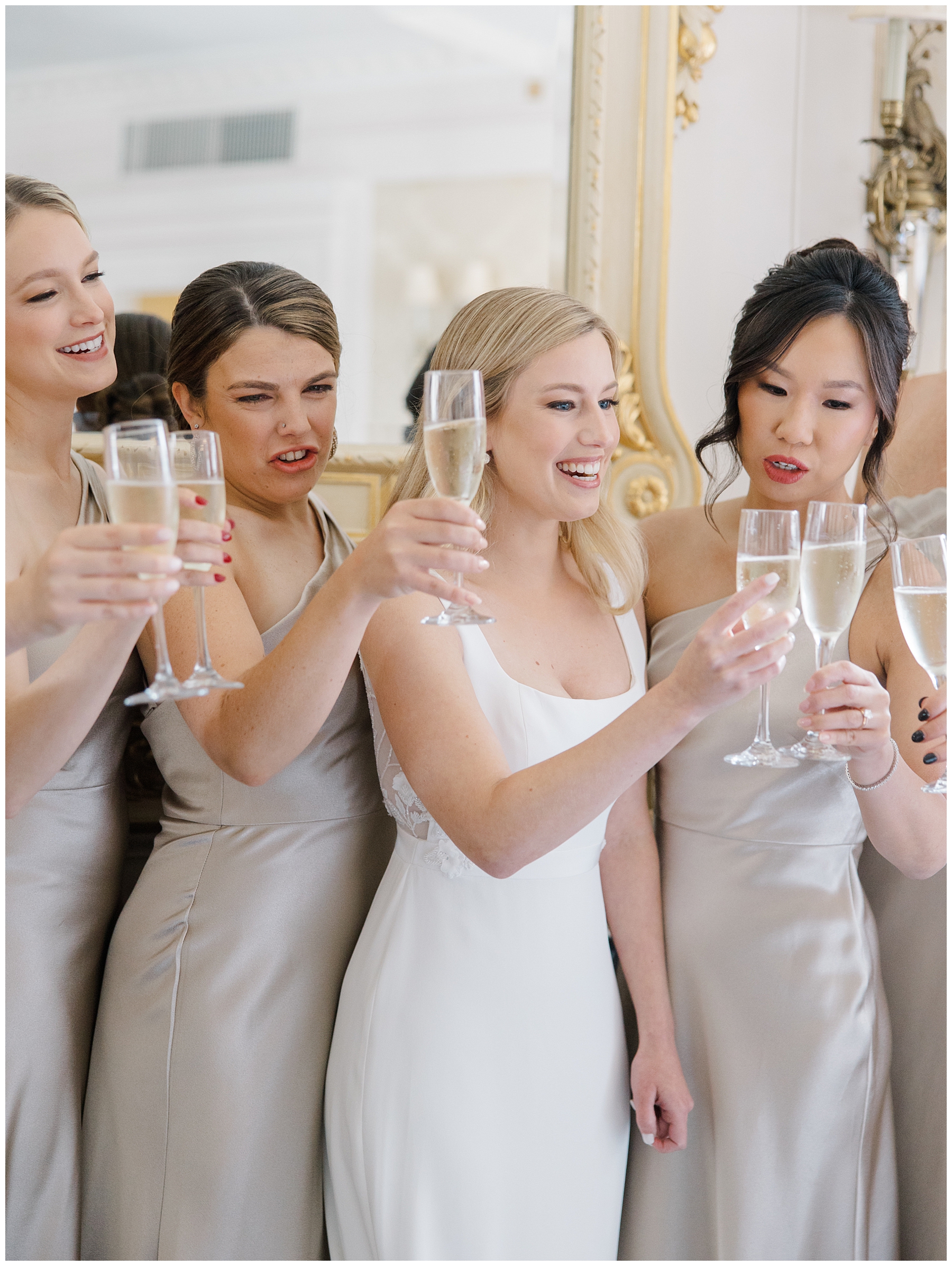 brides and bridesmaids toast with champagne