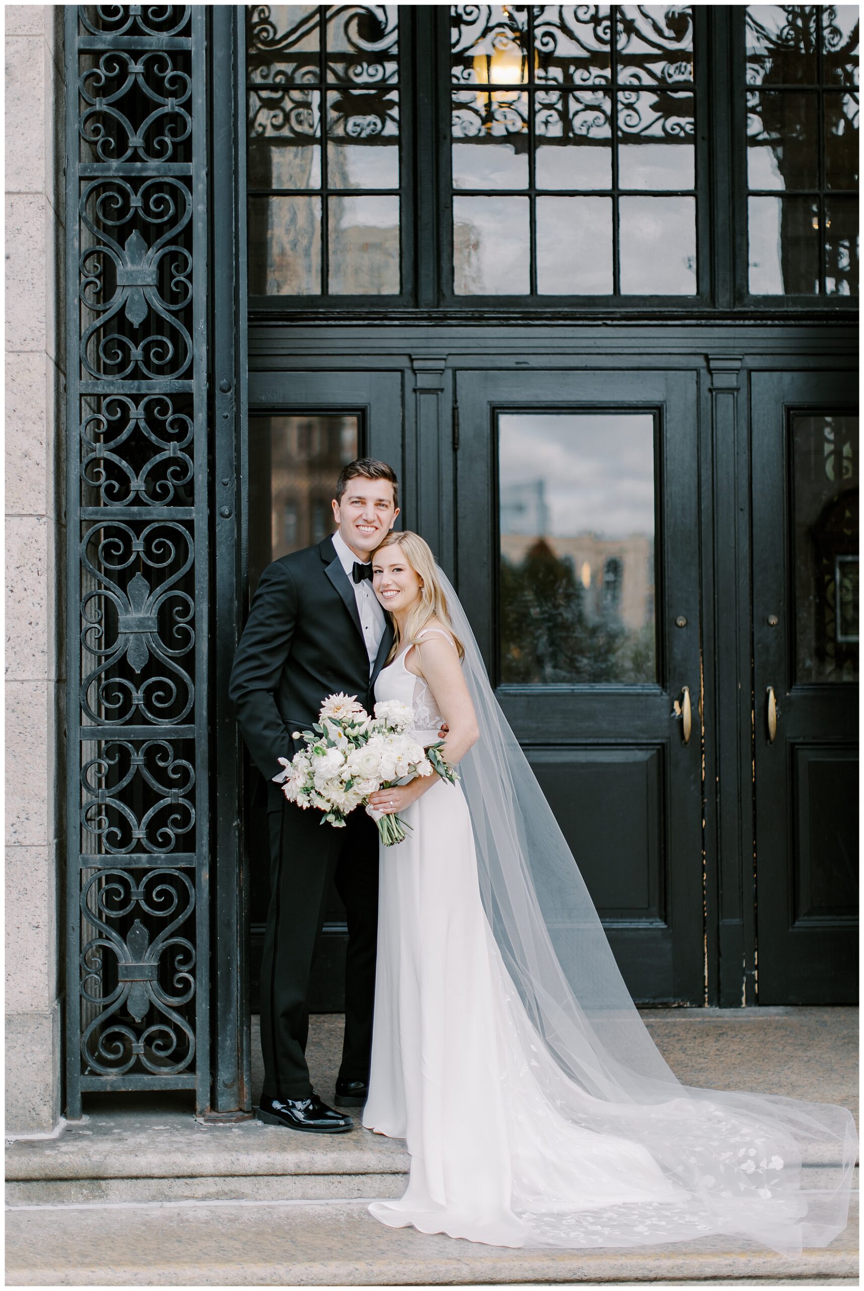 romantic wedding photos of bride and groom in the doorway of Boston Public Library