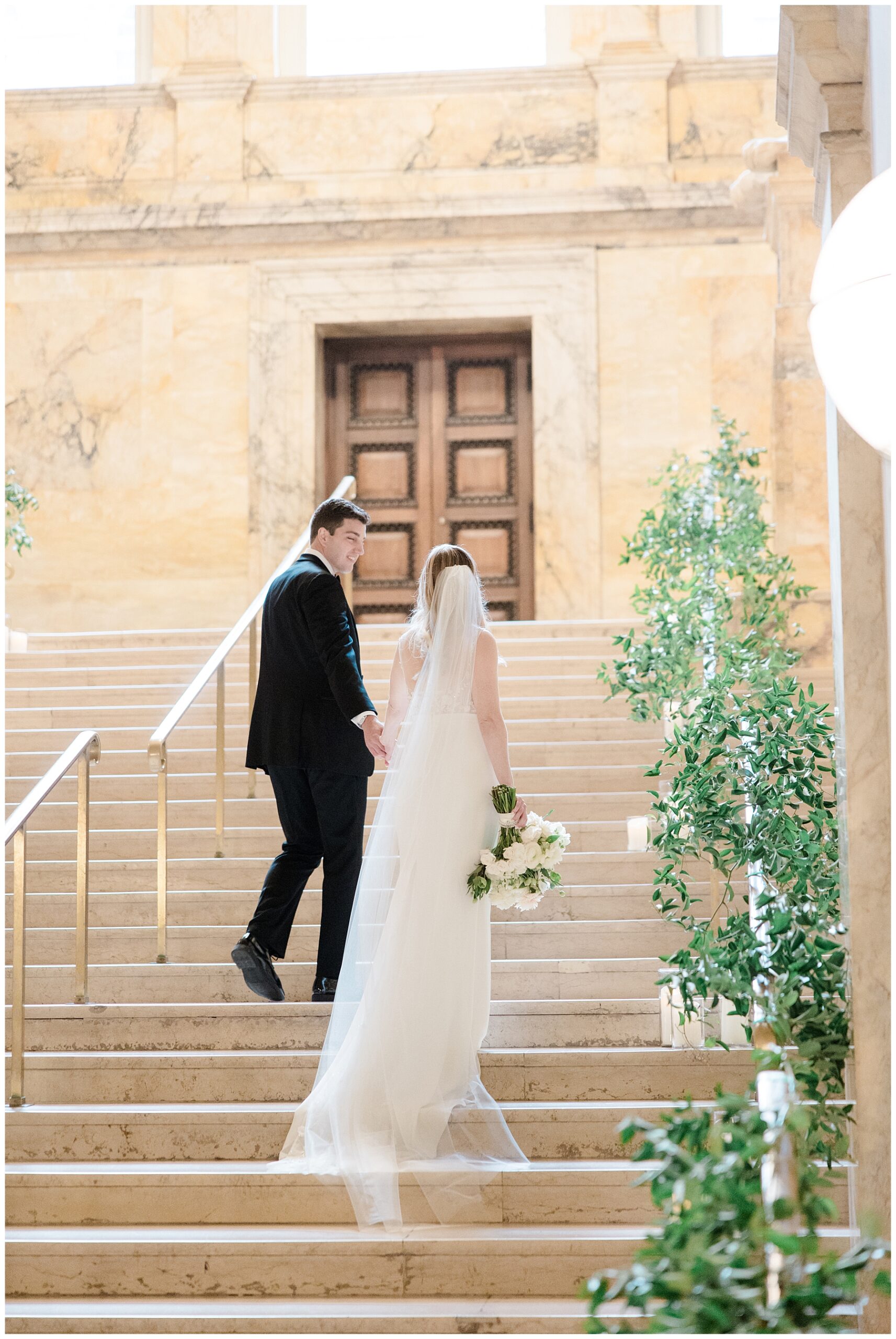 wedding photos of couple walking up the stairs
