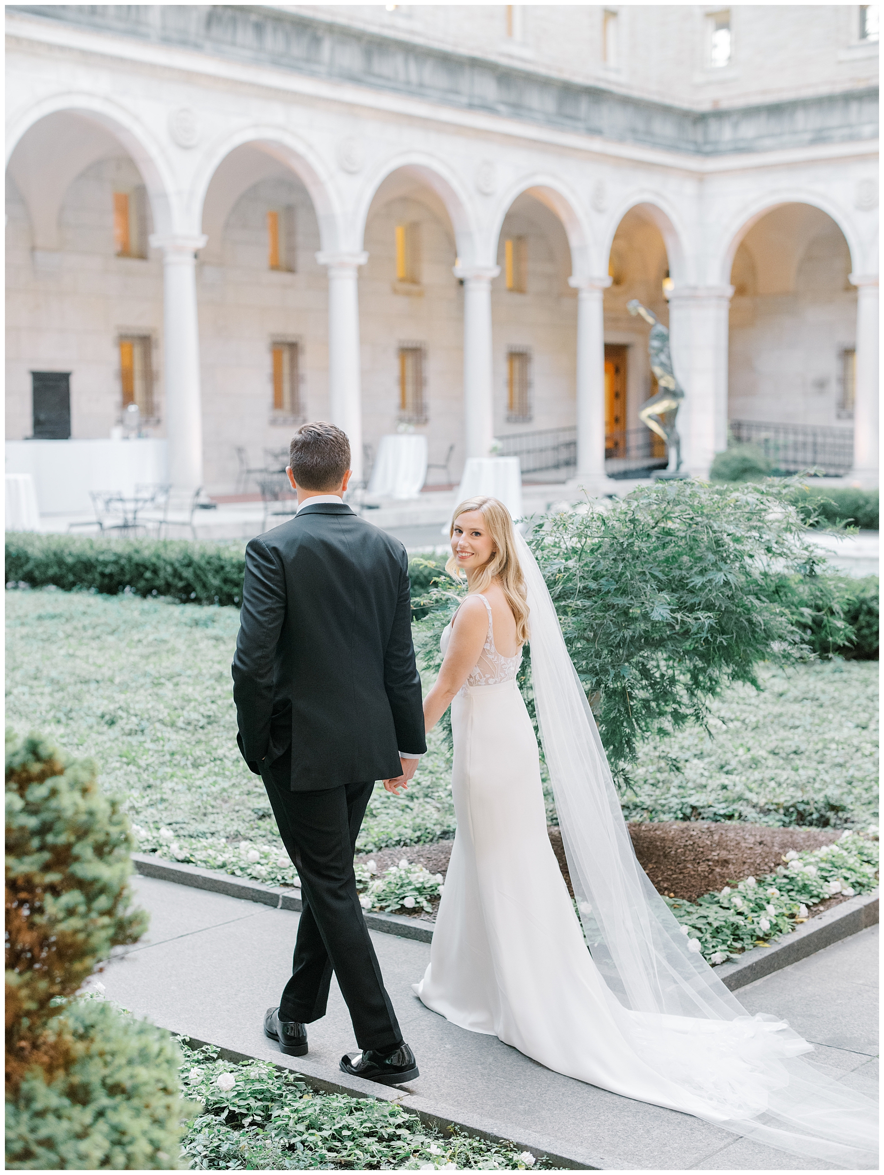 newlyweds walk in the Courtyeard of BPL