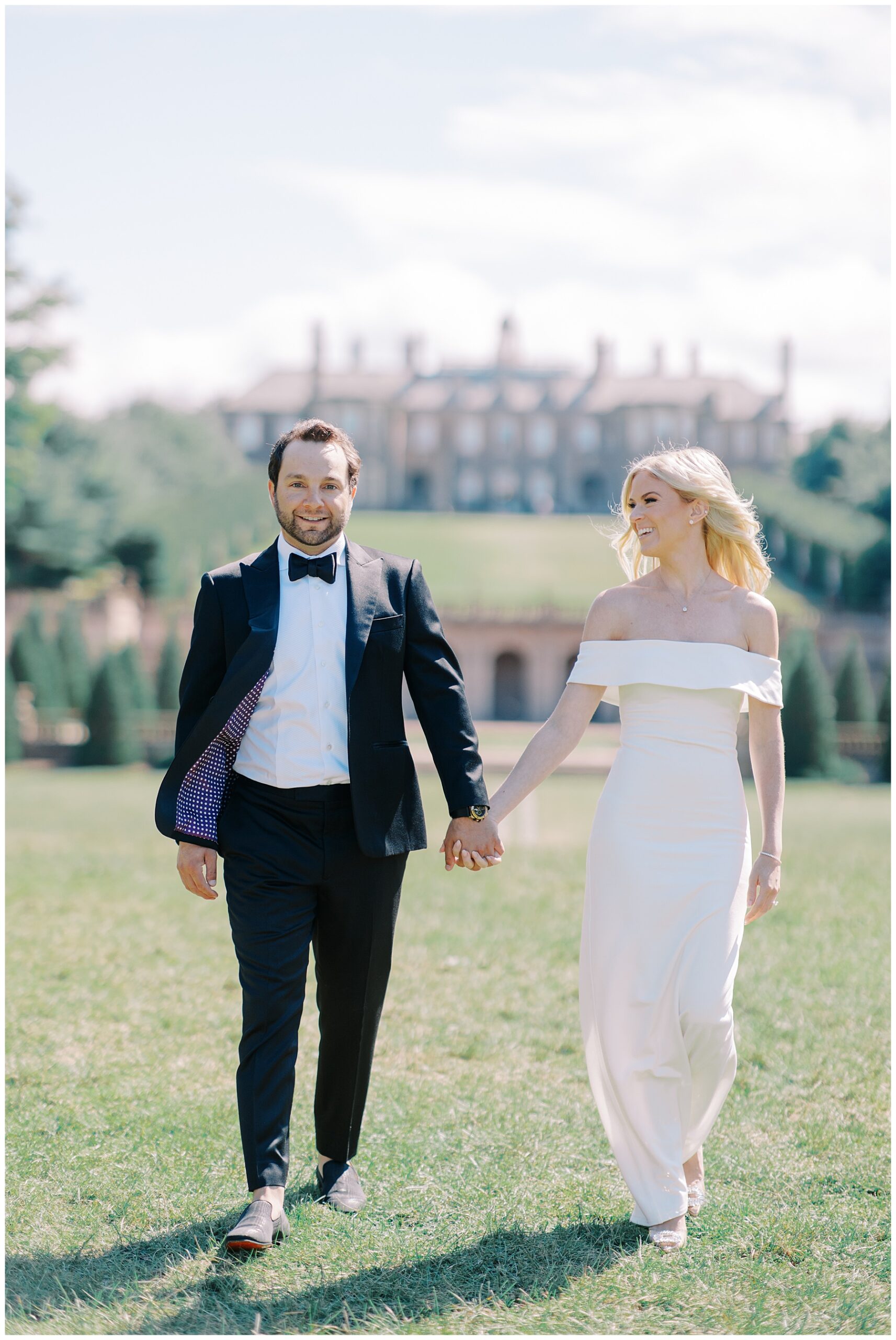 couple walking together holding hands at The Crane Estate in Ipswich, MA