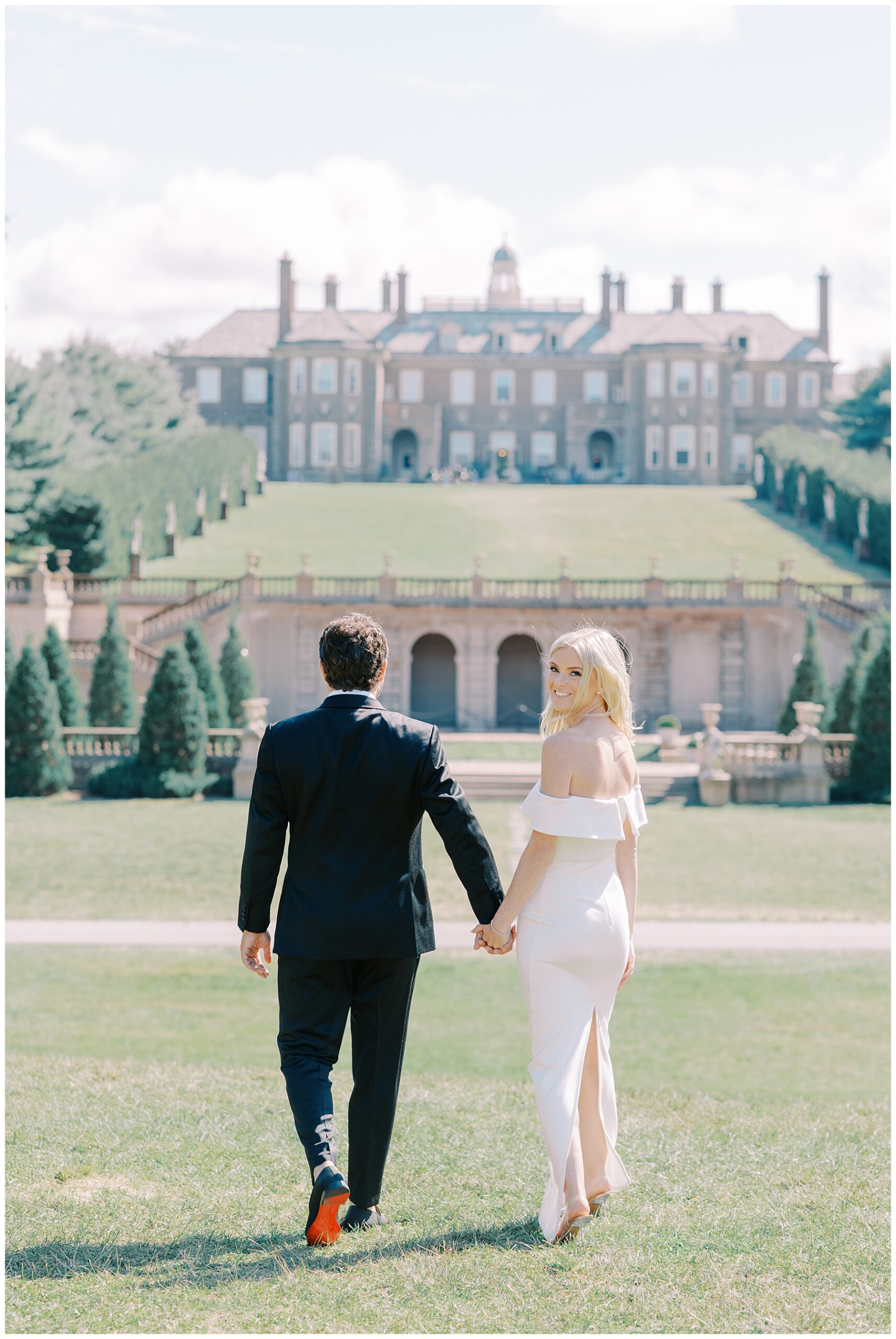 couple holding hands walking towards the Crane Estate Building