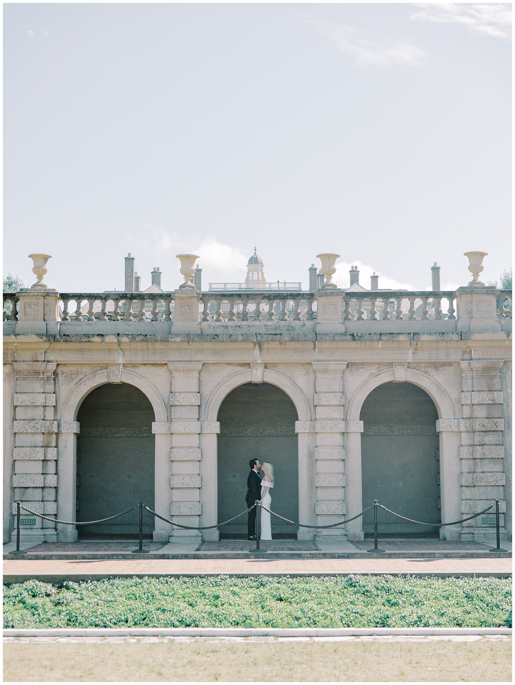 classic engagement photos in archway of building