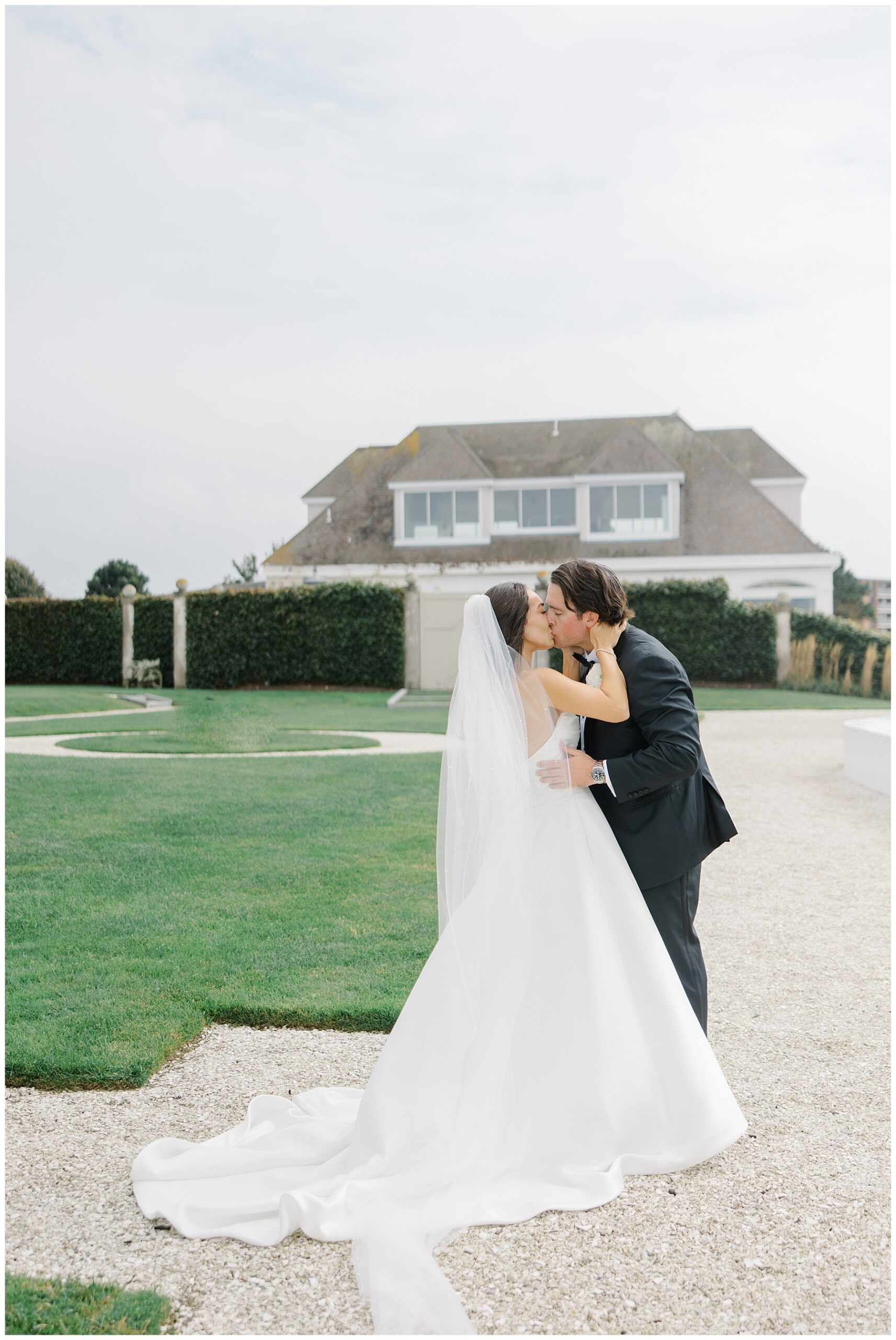 bride and groom hug during first look in front of Coastal venue, Belle Mer in Newport