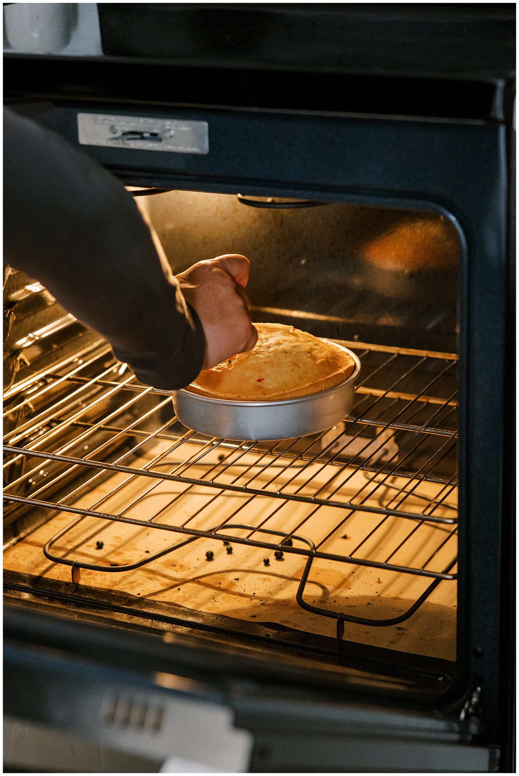 guy checks cake in oven