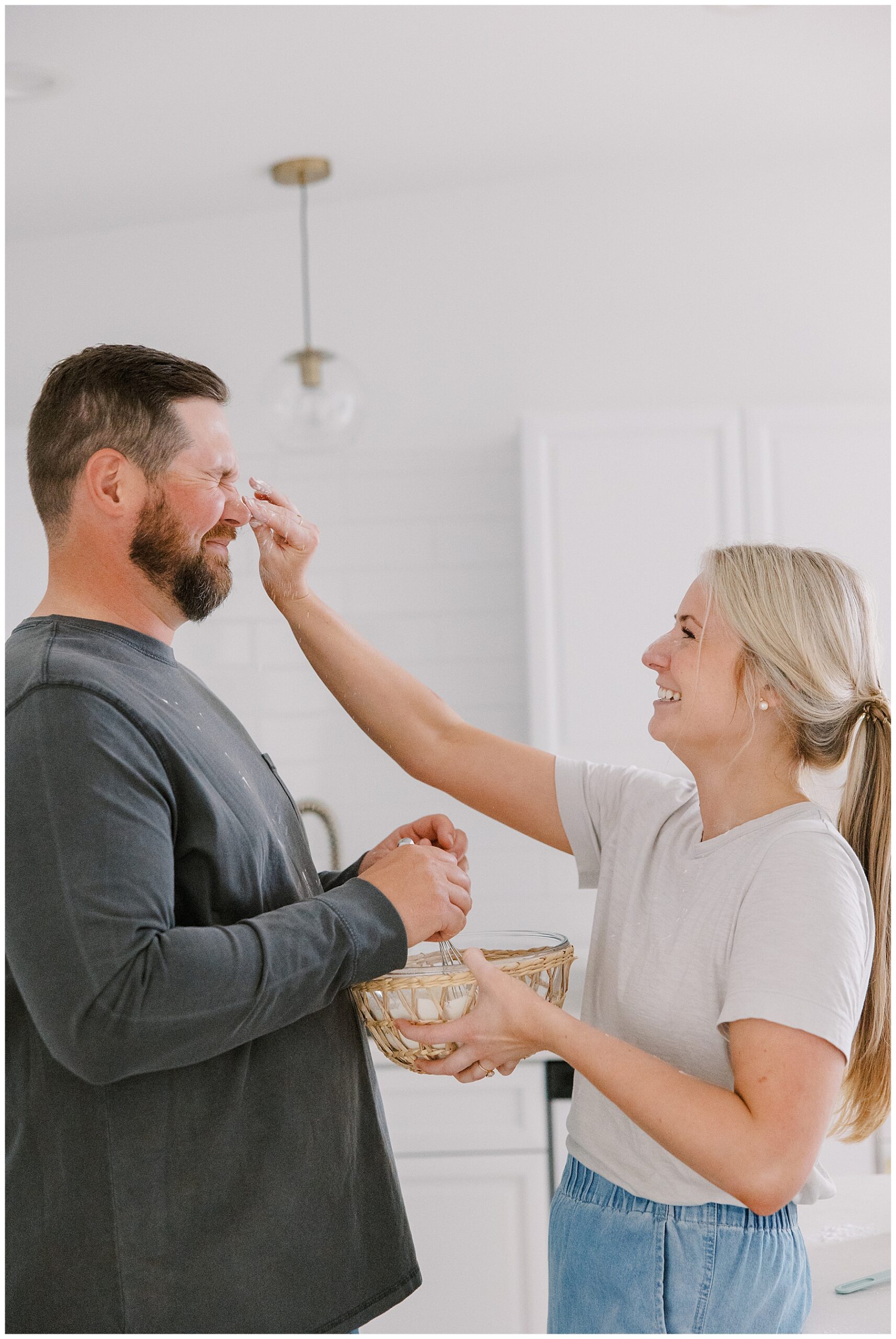 woman puts flour on fiance's nose