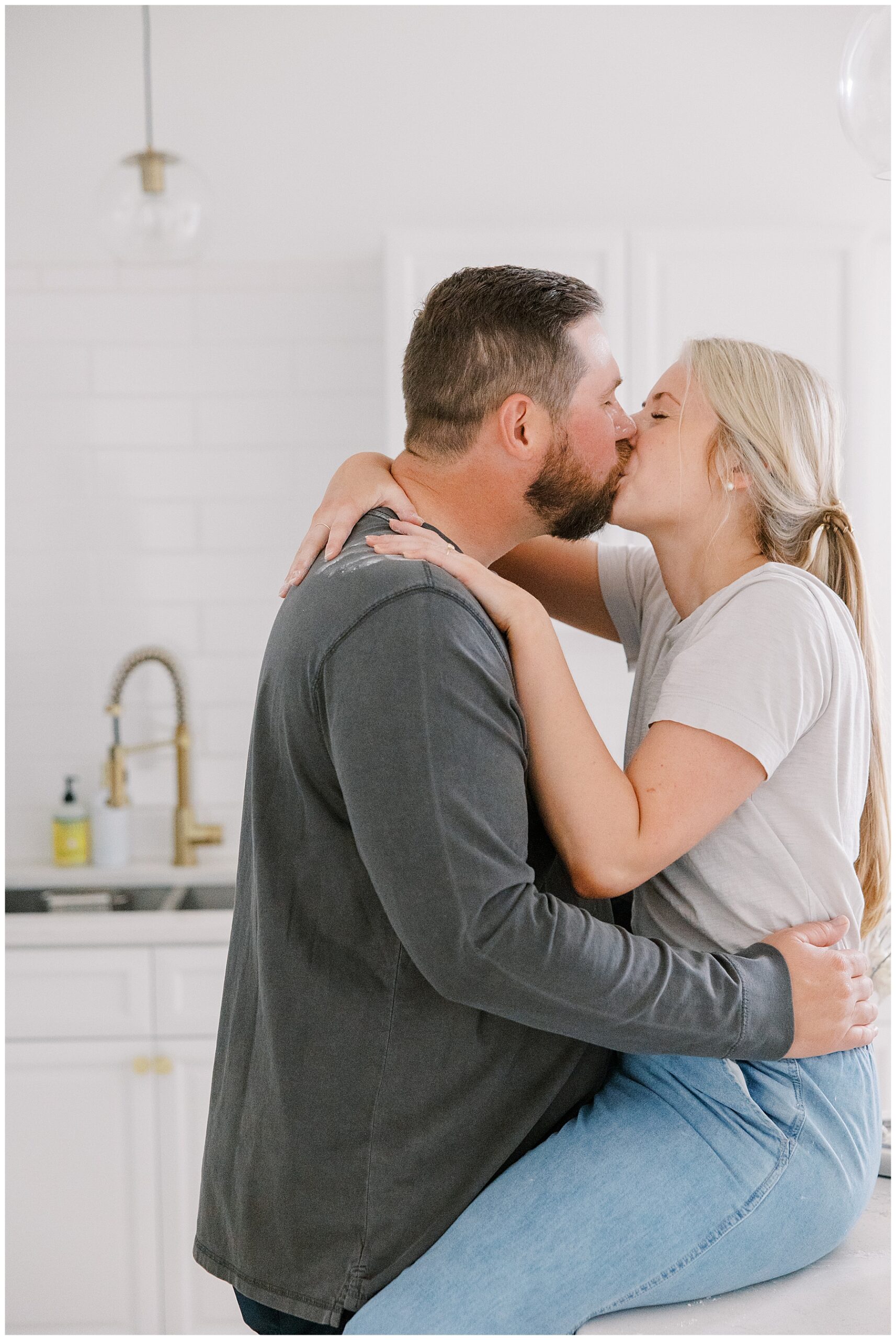 couple kiss with woman on counter