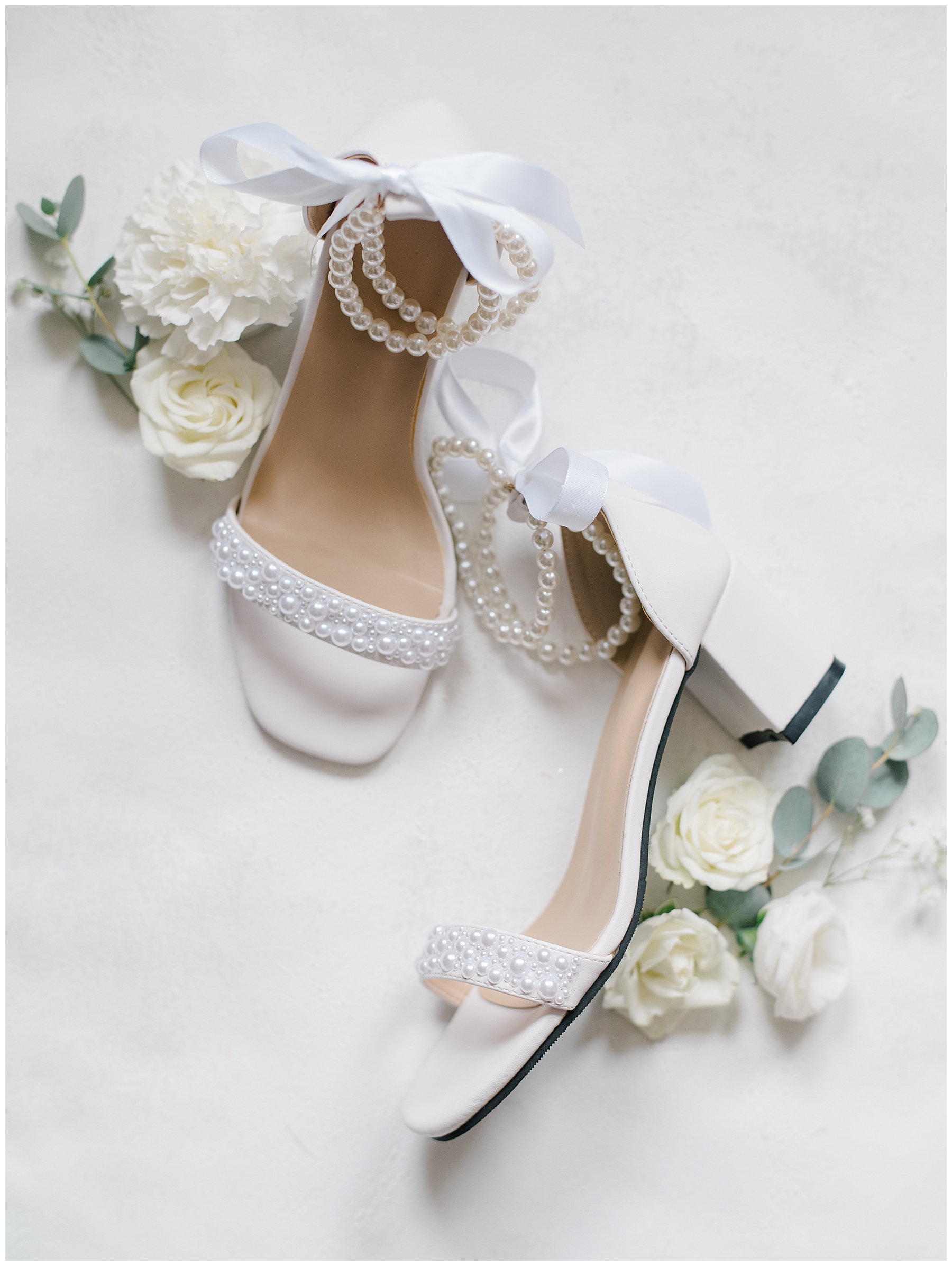 bride's wedding shoes with pearls