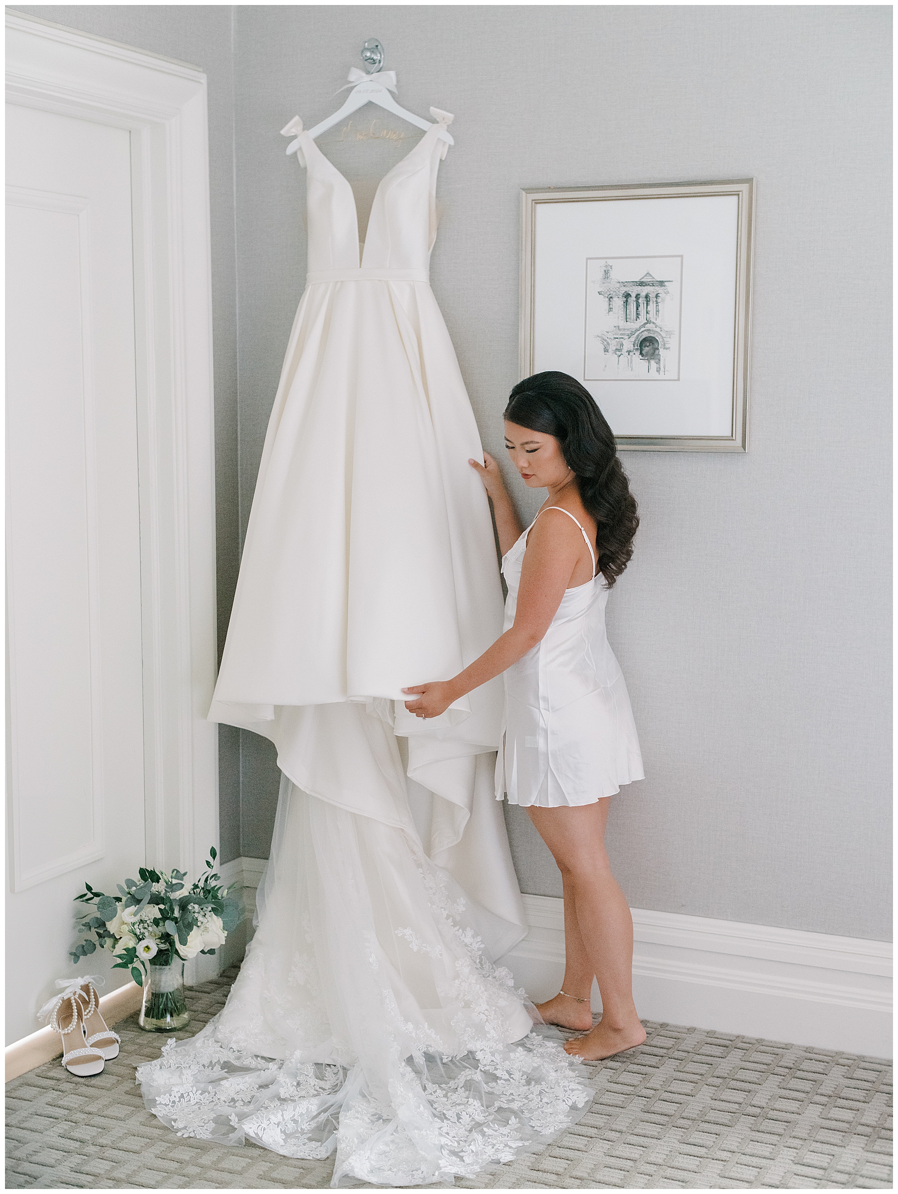 bride admires wedding dress