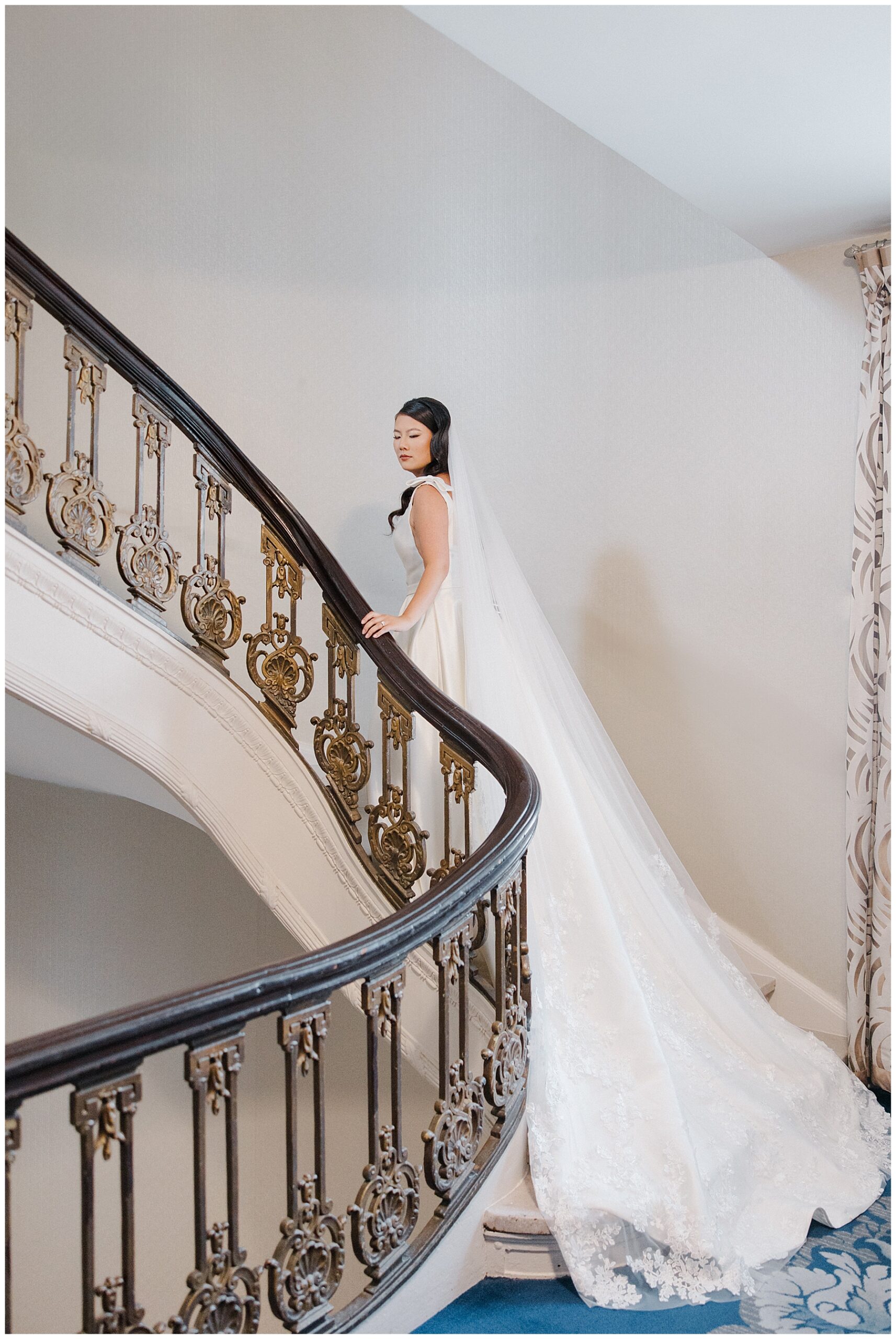 Bride ascends spiral staircase