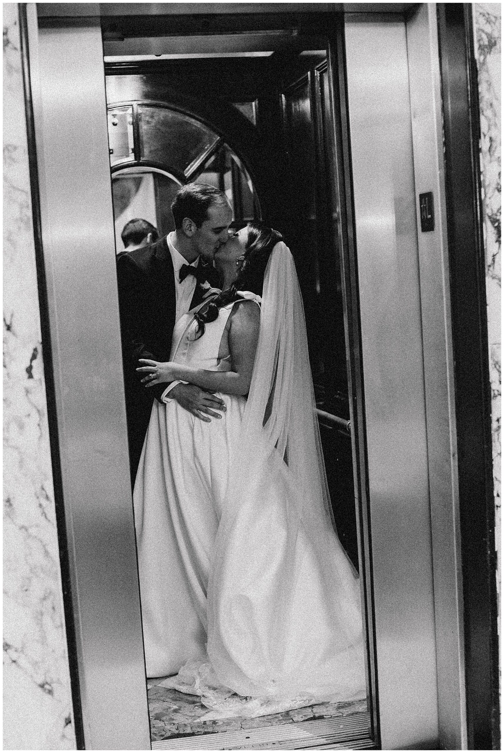bride and groom kiss in elevastor