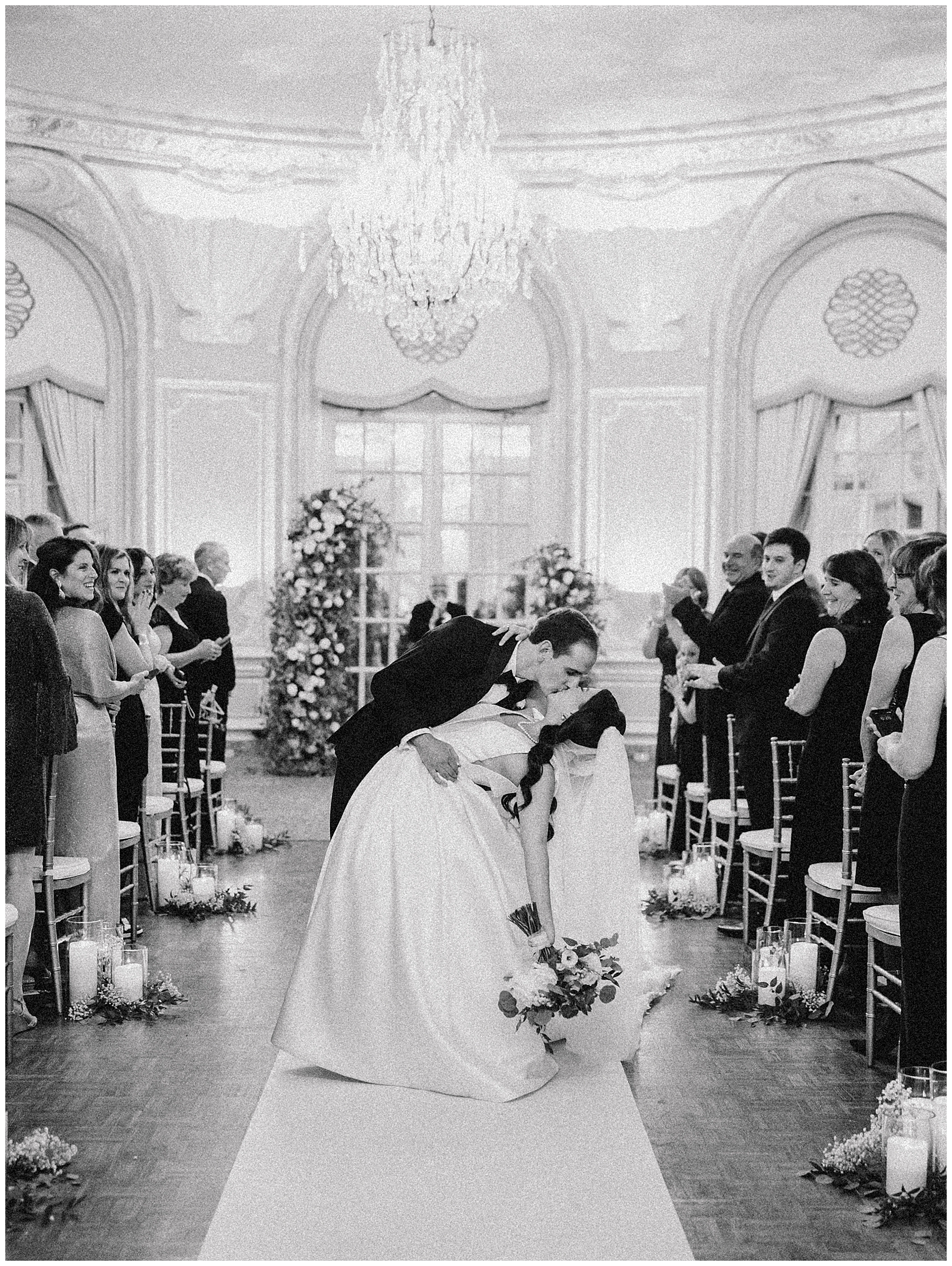 newlyweds kiss as they exit wedding ceremony