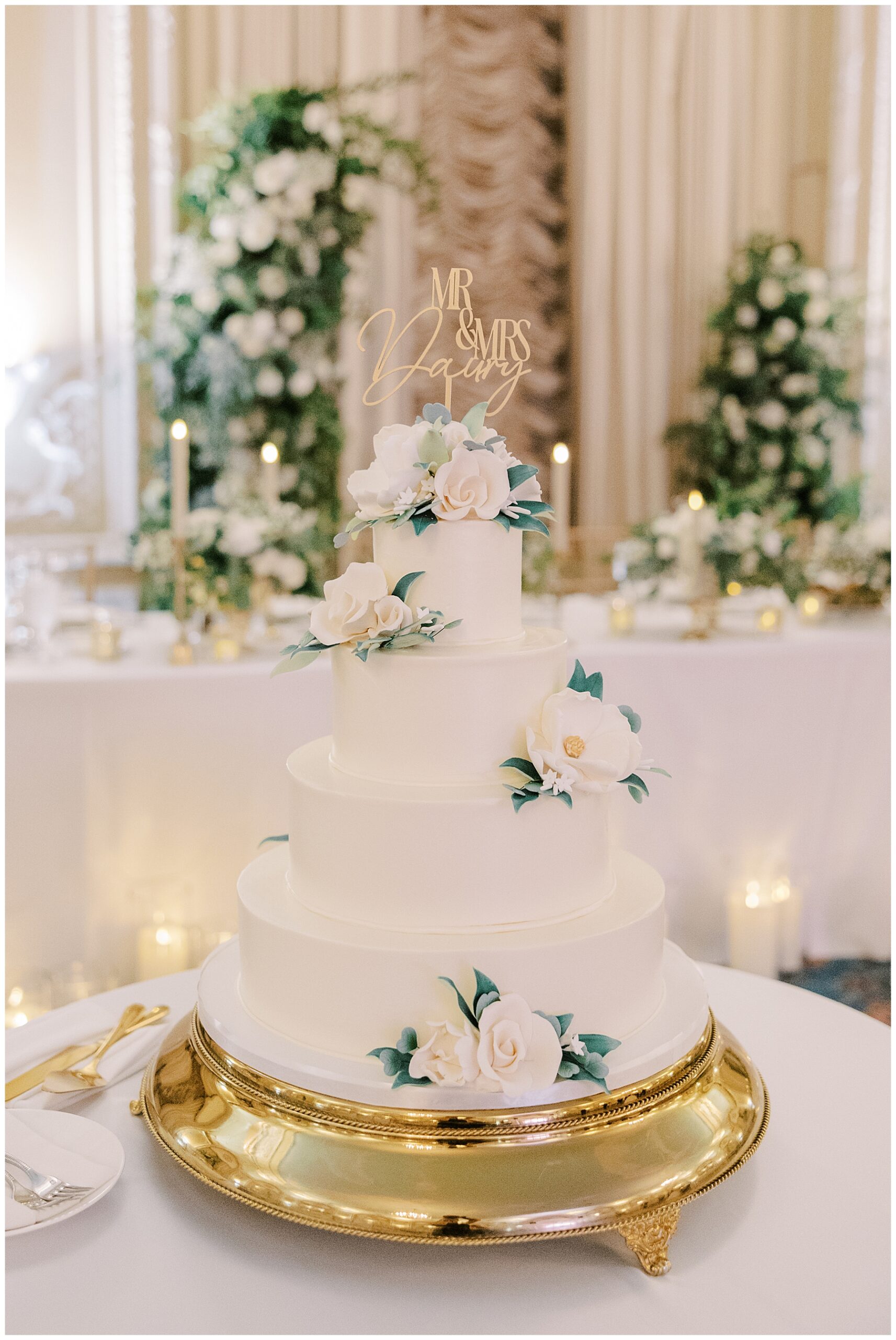 4 tiered wedding cake with white flower details