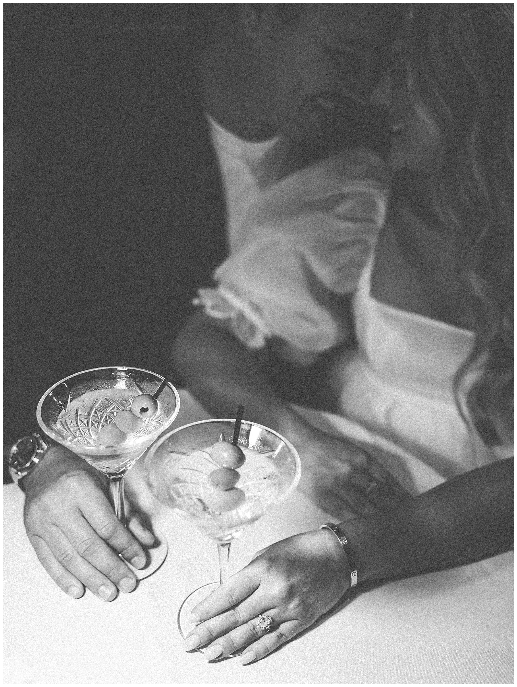 couple laugh while drinking a martini