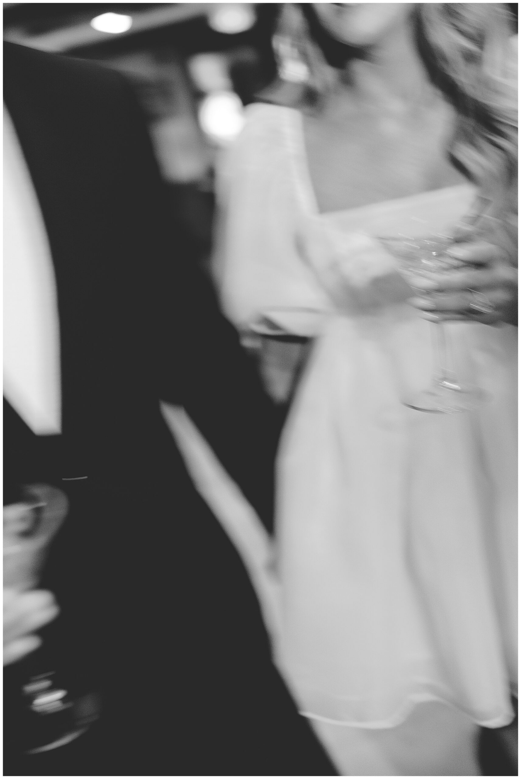couple holding martinis during engagement session