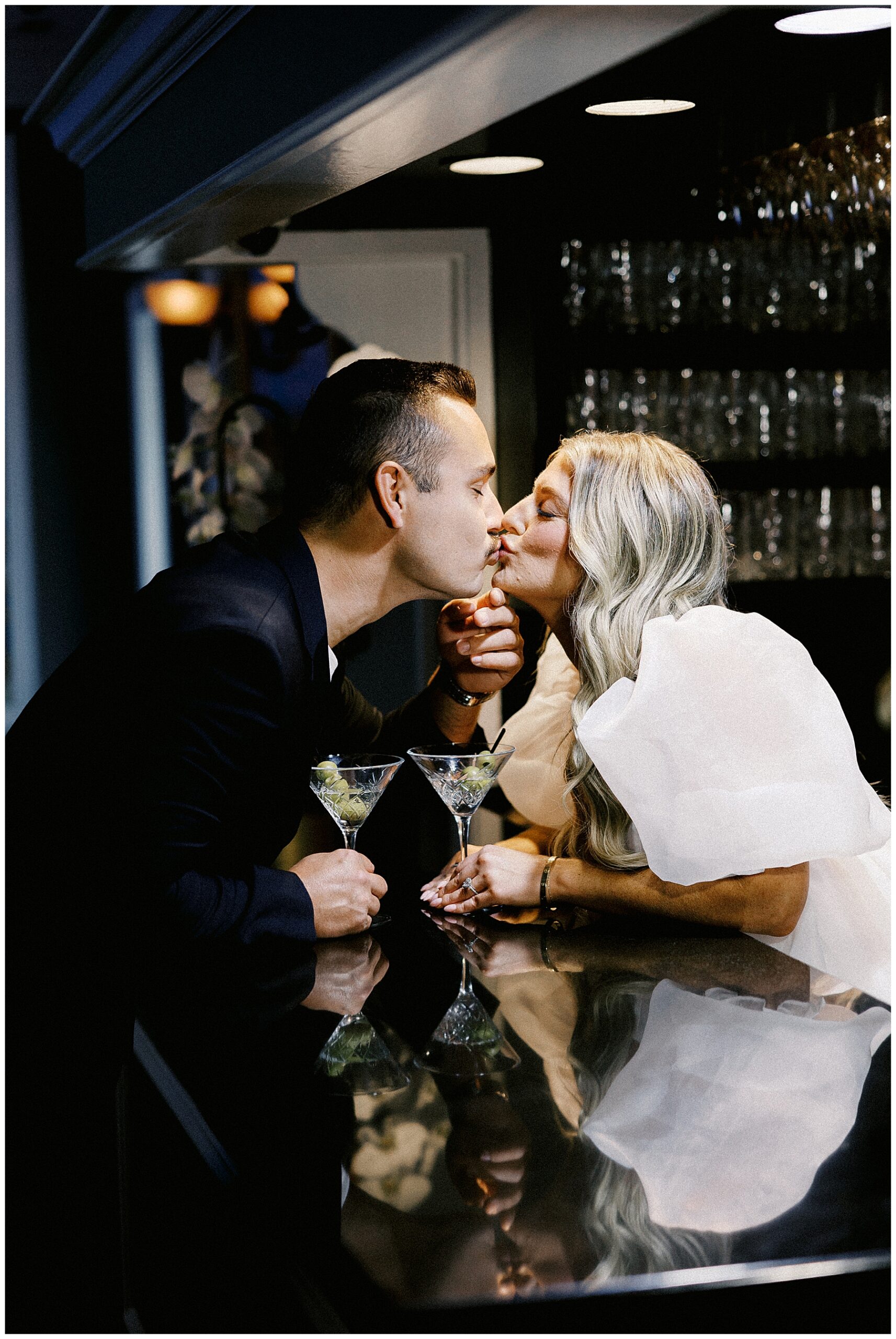 couple kiss across bar