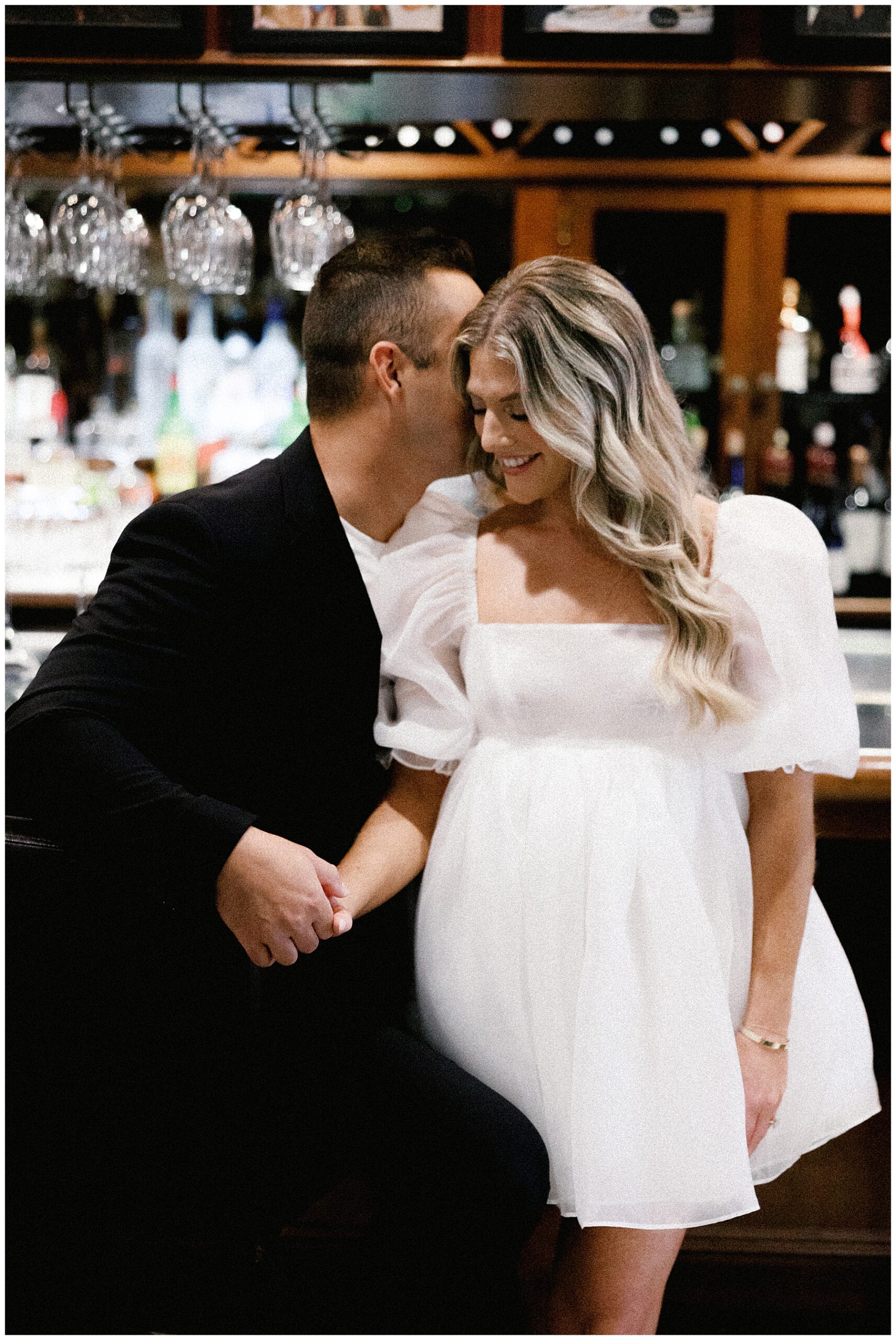 guy whispers in fiancé's ear