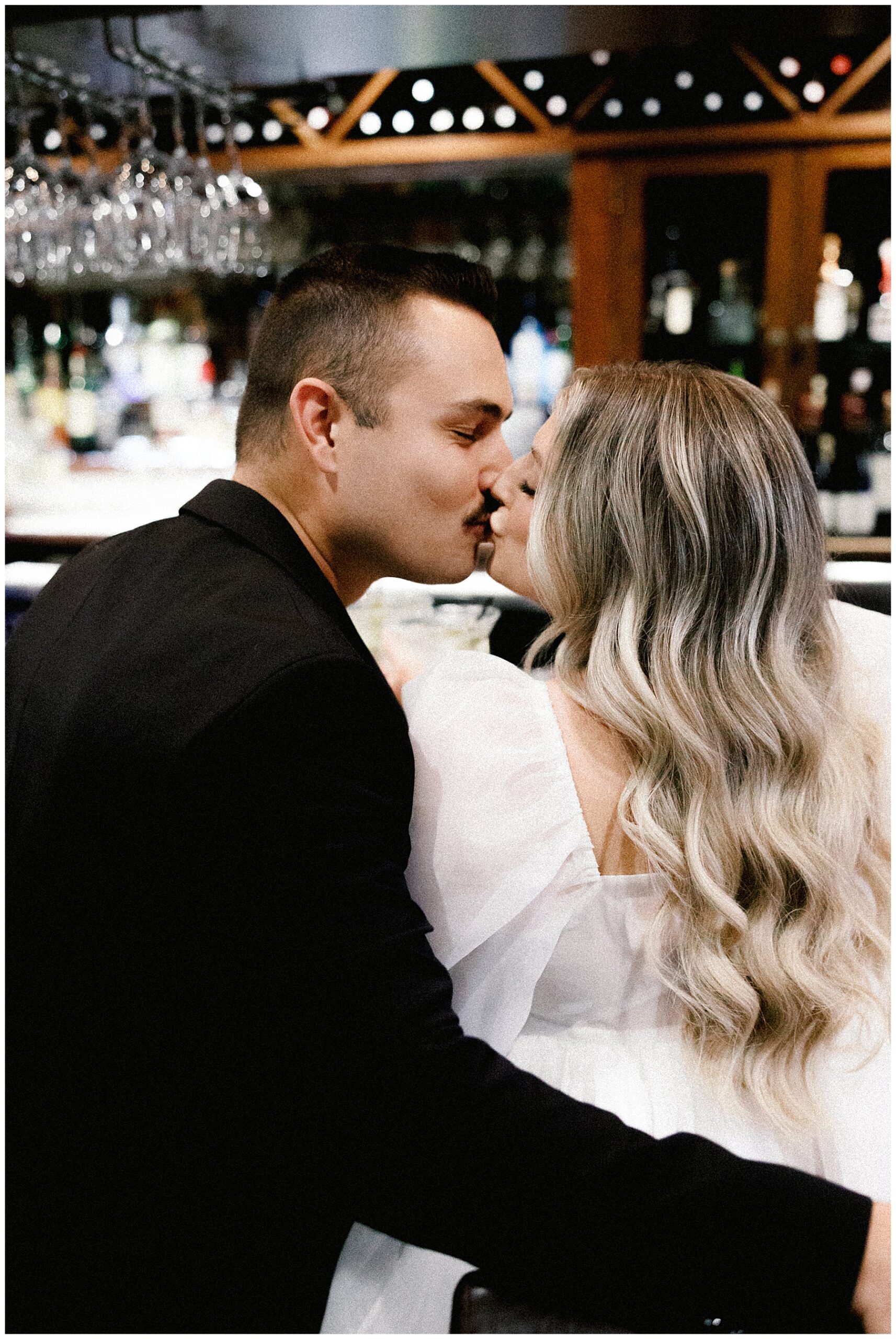 engaged couple kiss