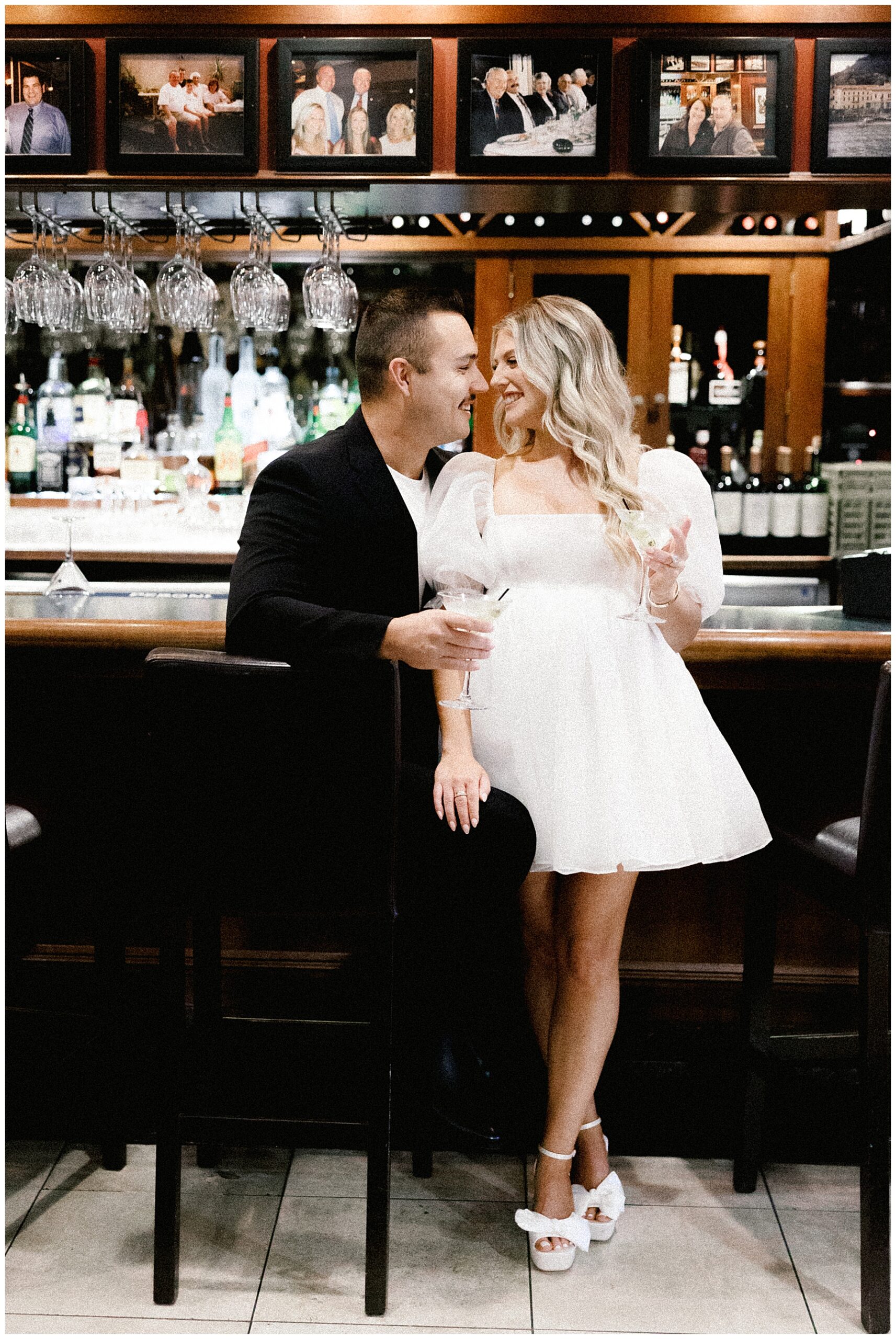 couple lean in together holding martinis